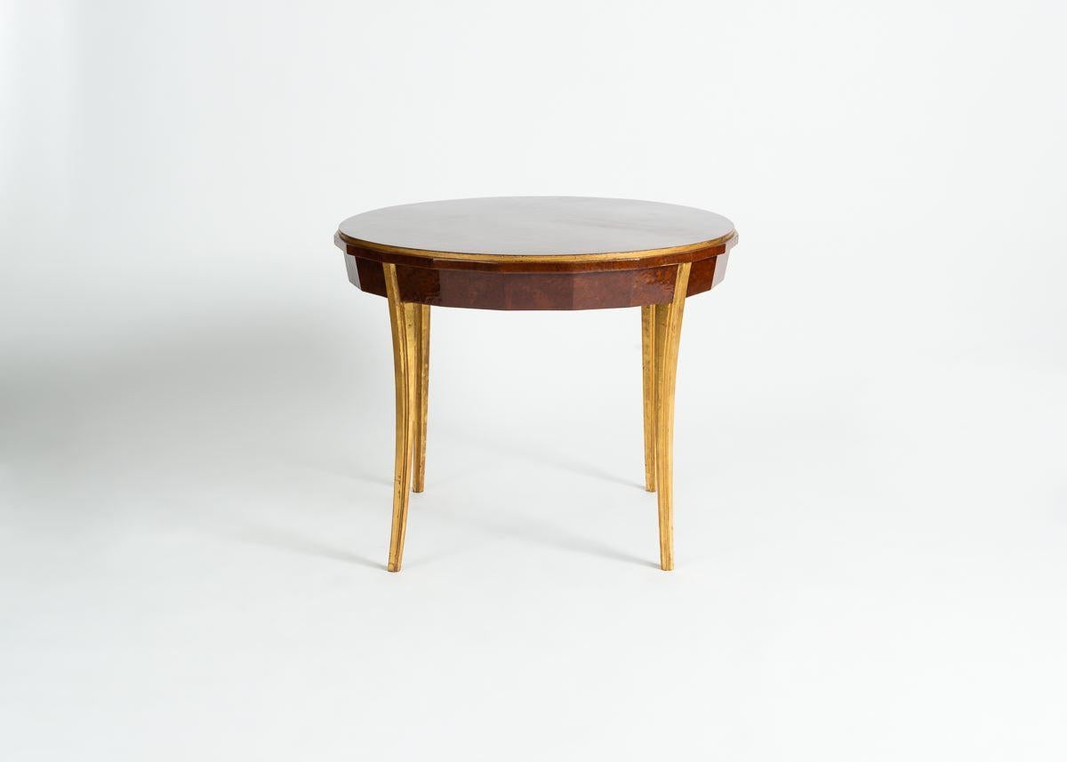 This beautiful occasional table by André Domin and Marcel Genevrière, made in France in late 1920s, rests on four subtly curved gilt-wood legs, and has a solid, round, and veneered top.

Stamped on plate: DOMINIQUE PARIS.