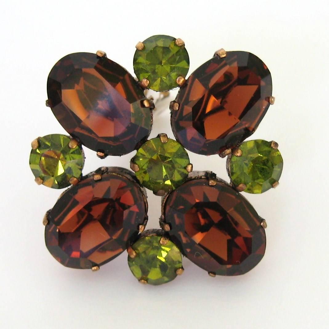 Dominique Aurientis Floral Rhinestone Earrings. Wonderful Brown and Green prong set Rhinestones make up these wonderful Clip on's, 1.7 in x 1.7 in. This French jewelry designer has a vast international customer base and is known throughout the world