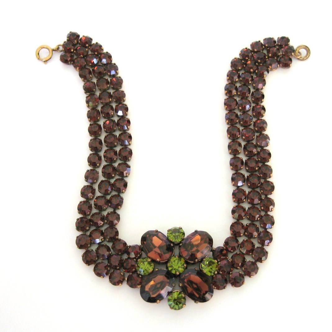 This set is breathtaking in person. A massive 3 strand Rhinestone choker, with a center Floral Motif. Color of Brown and Green look spectacular together. Rhinestones are prong set. Hallmarked Dominique Aurientis on the underside of Necklace.