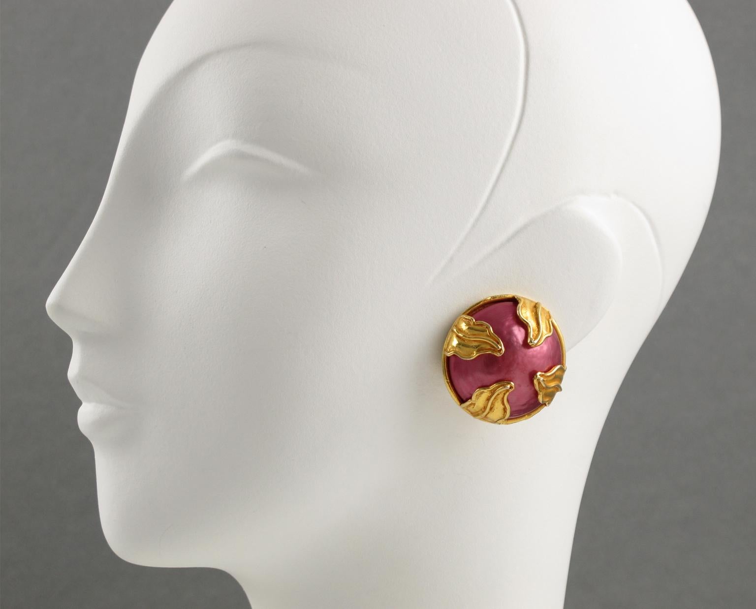 Elegant Dominique Aurientis Paris signed clip-on earrings. Features round gilt metal framing topped with a hot pink pearl-like enamel cabochon ornate with gilt metal leaves. Signed with the 