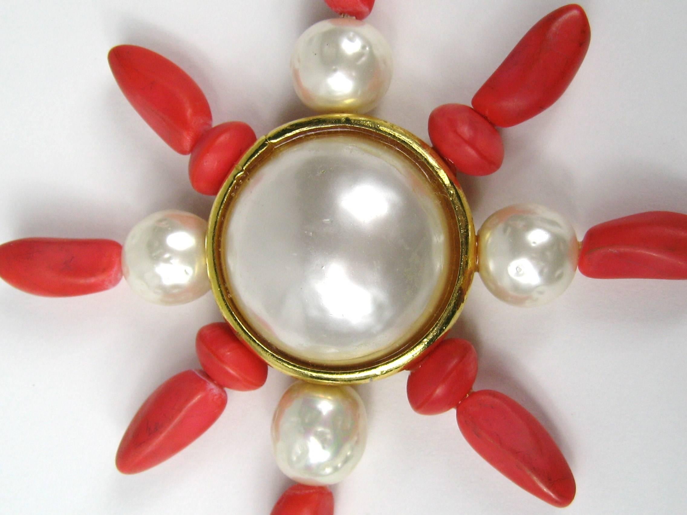 Aurientis Large Coral colored with Baroque Pearl center and accent. Measures 3.80 in  Made in France. Dominique Aurientis started her career in the Dior atelier, moving on to the houses of Chanel, Givenchy, Lavin, Ferragamo, Pucci and Celine. This