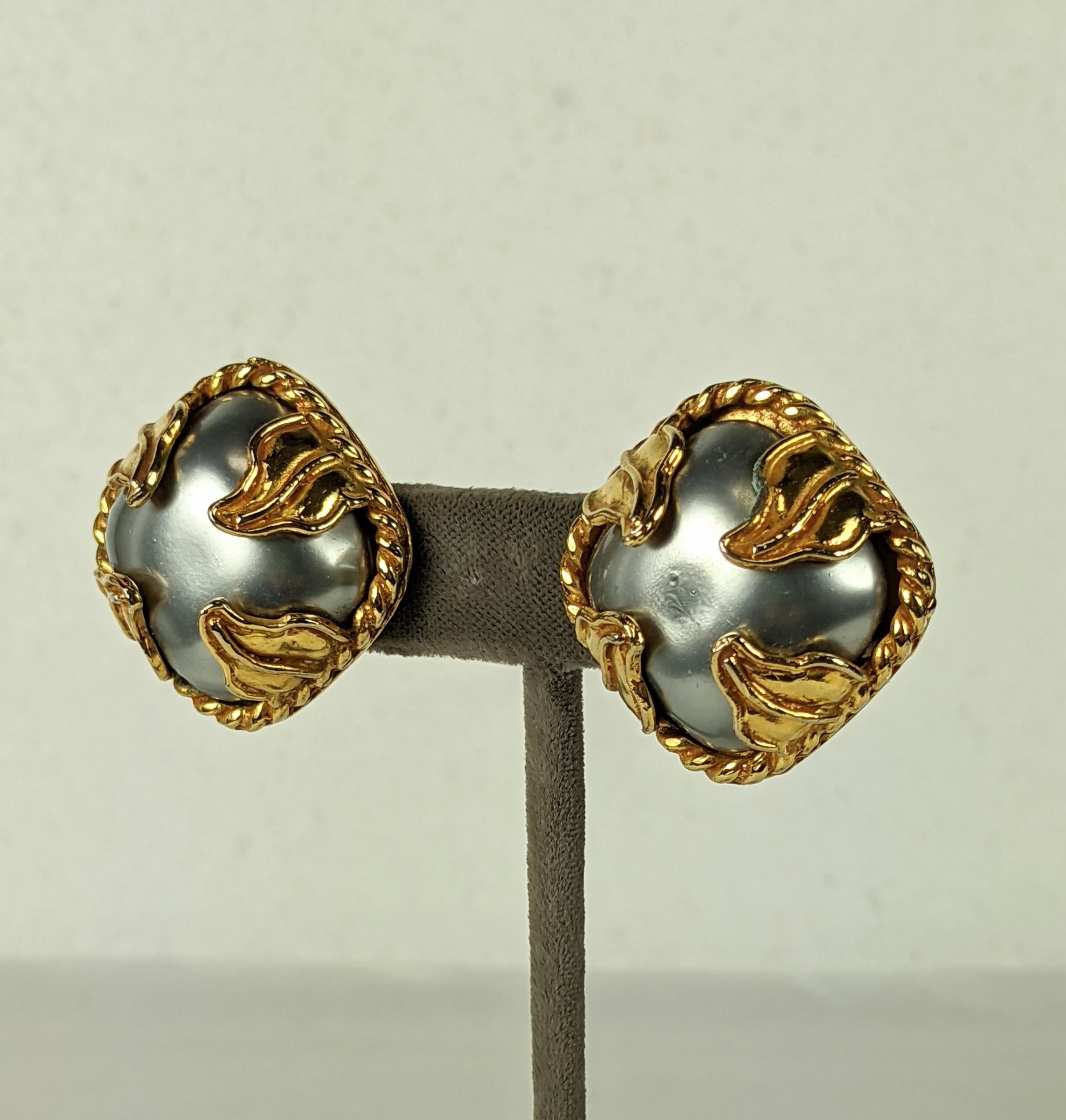 Elegant Dominique Aurientis Gray Pearl Earrings from the 1980's. Square cabochon faux gray pearls are set within large gilt leaf form prongs with twisted gold borders. 1.25