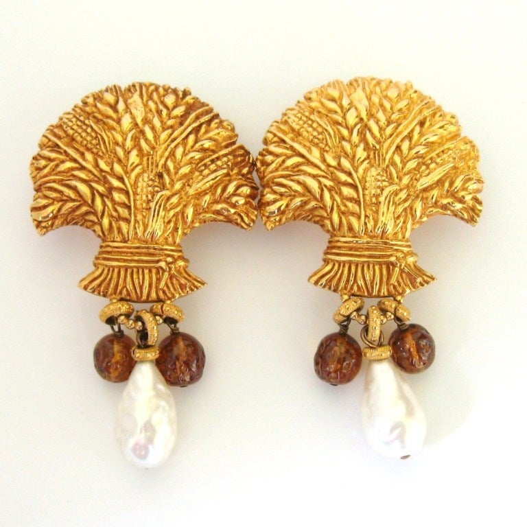 Dominique Aurientis with an Exquisite Large gold tone dangle earrings. They Poured glass and Baroque pearl dangling from a large clip on. This a huge earrings and will make a statement! We have other pieces of her amazing jewelry on our storefront.