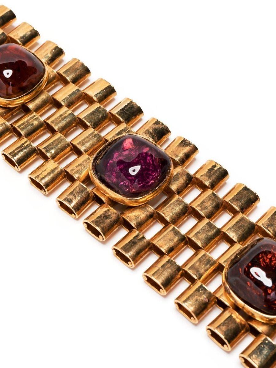 From the Parisian jeweller Dominique Aurientis this pre-owned bracelet boasts a chunky tank design embellished by cabochons of brown glass paste and amethyst. Secured with a clasp fastening this piece is both Dramatic and elegant.

Colour: Light