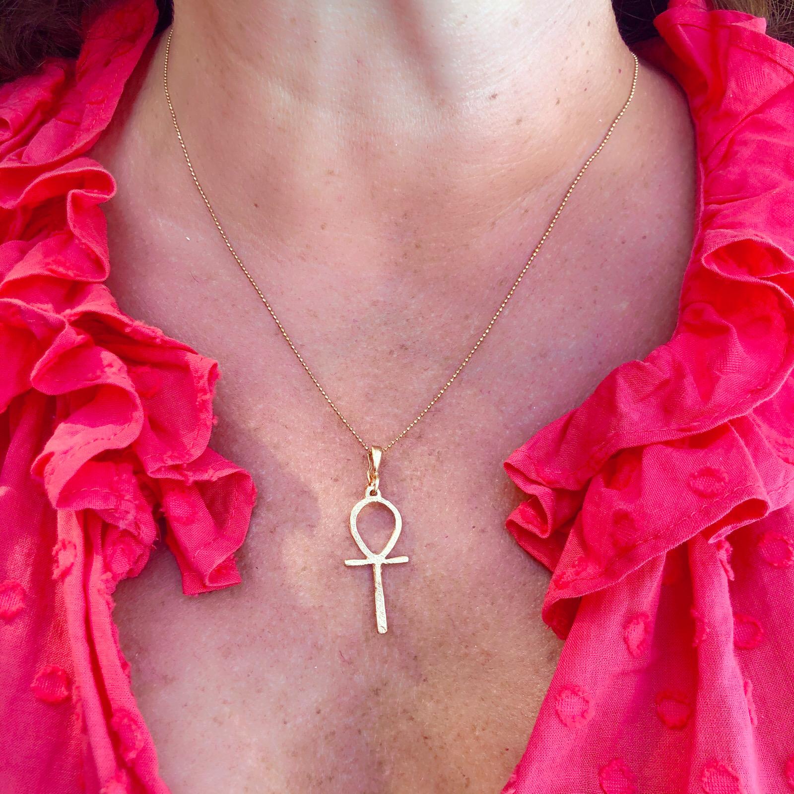 Iconic, collectible Dominique Cohen.  The ankh, also known as the key of life, was the ancient Egyptian hieroglyphic character for life and represents the concept of eternal life. The 18k gold pendant-enhancer, measuring 1 5/8in., is suspended from