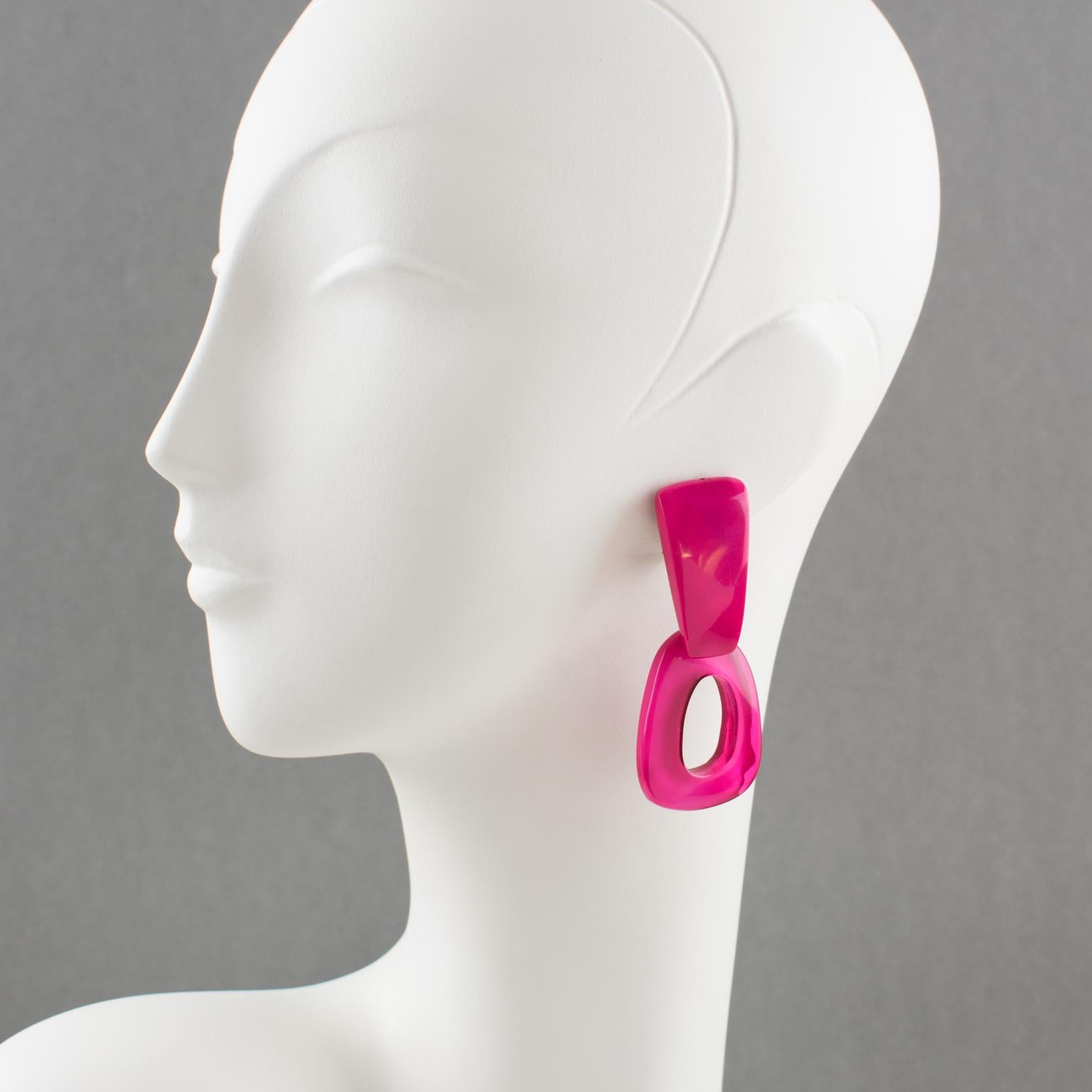 Lovely dangling clip-on earrings by Dominique Denaive Paris. Sculptural oversized chandelier shape, textured resin donut pebbles with hand made feel in vivid hot pink color and silvered metal fixture. Signed on the clasp with silvered metal tag