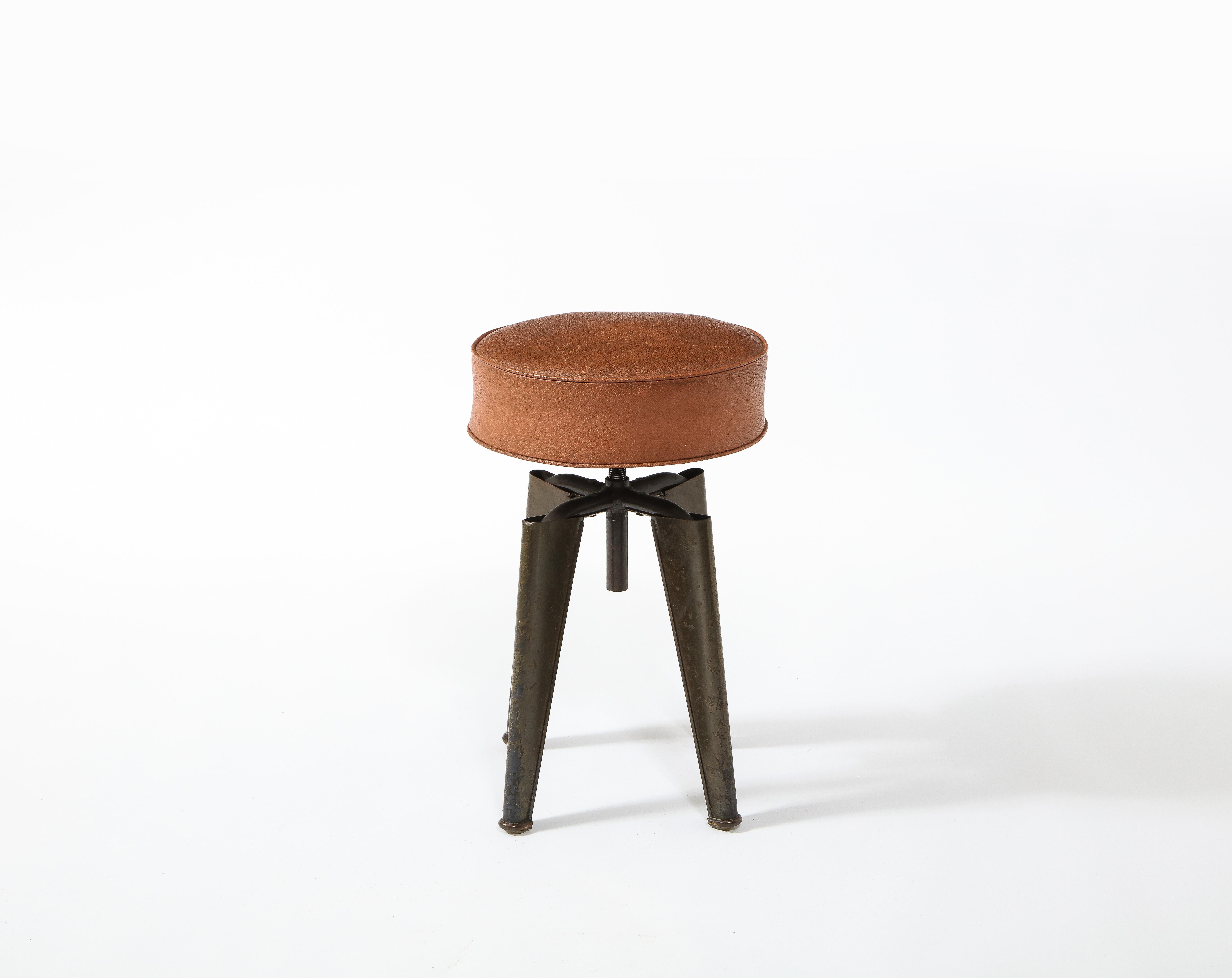 A bent steel adjustable stool in original finish and upholstery from the French Navy ship 