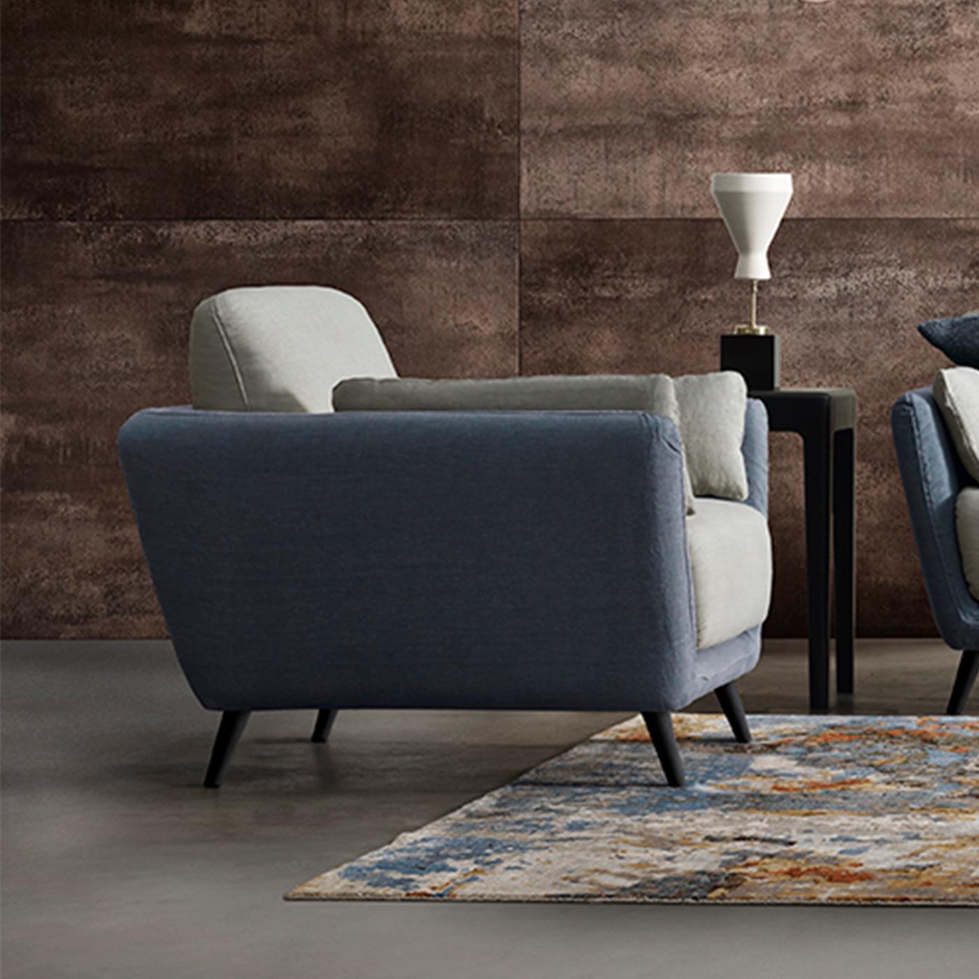 A charming contemporary take on classic furnishings, the Domino Armchair is completely personalizable to suit your tastes. Shown here with linen upholstery in Jeans and Celestino with walnut legs in Modo10's Havana finish, the chair is also easy to