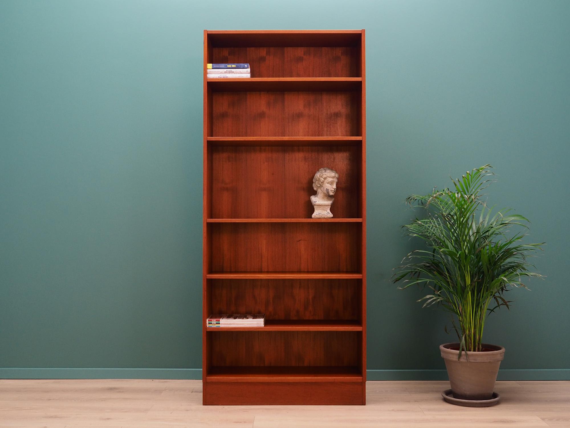 Classic bookcase, library from the 1960s-1970s. Scandinavian design, Minimalist form. Manufactured by Domino Møbler. The furniture is finished with teak veneer. Shelves with adjustable height. Preserved in good condition (small bruises and