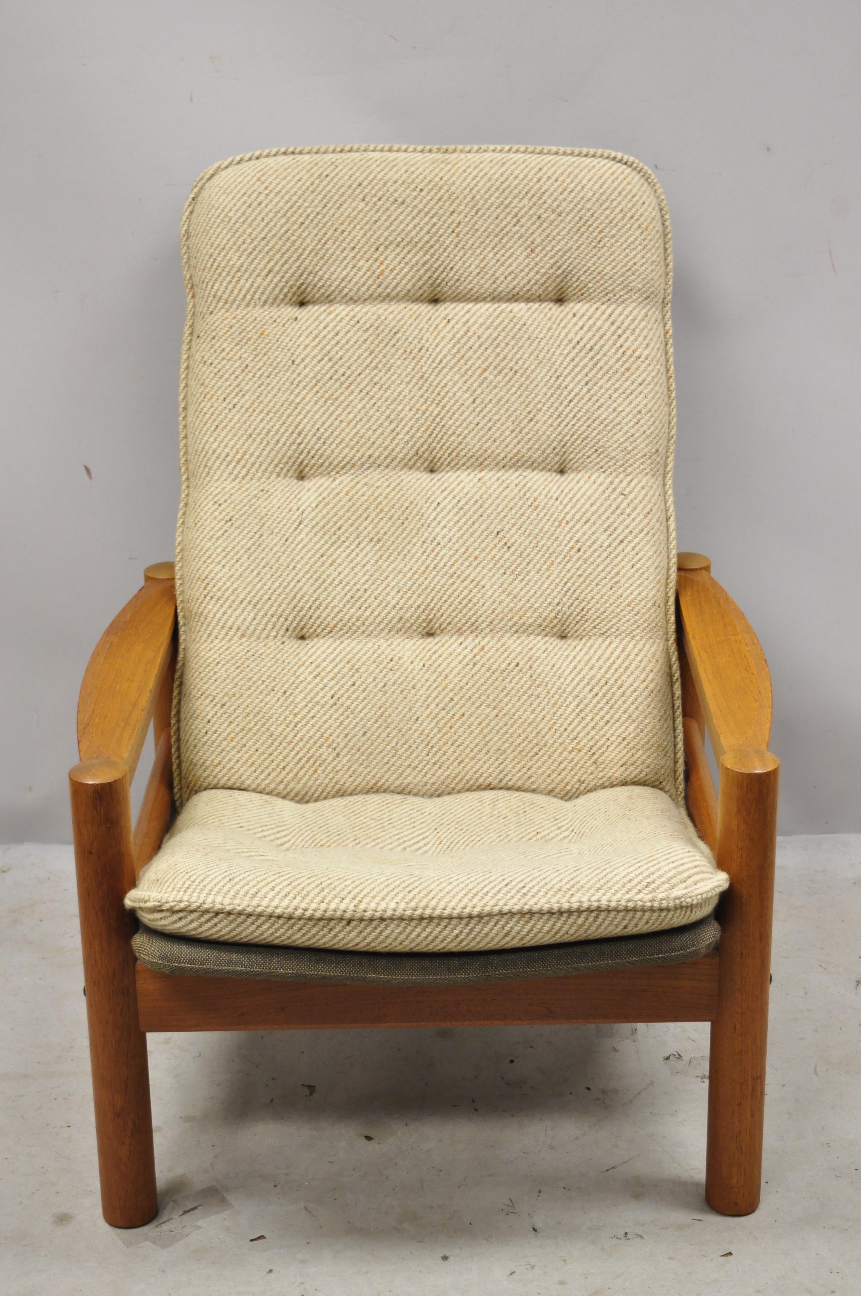 Domino Mobler mid century Danish modern teak wood upholstered lounge chair. Item features solid wood frame, beautiful wood grain, original label, clean modernist lines, quality Danish craftsmanship, great style and form. Circa Mid 20th Century.