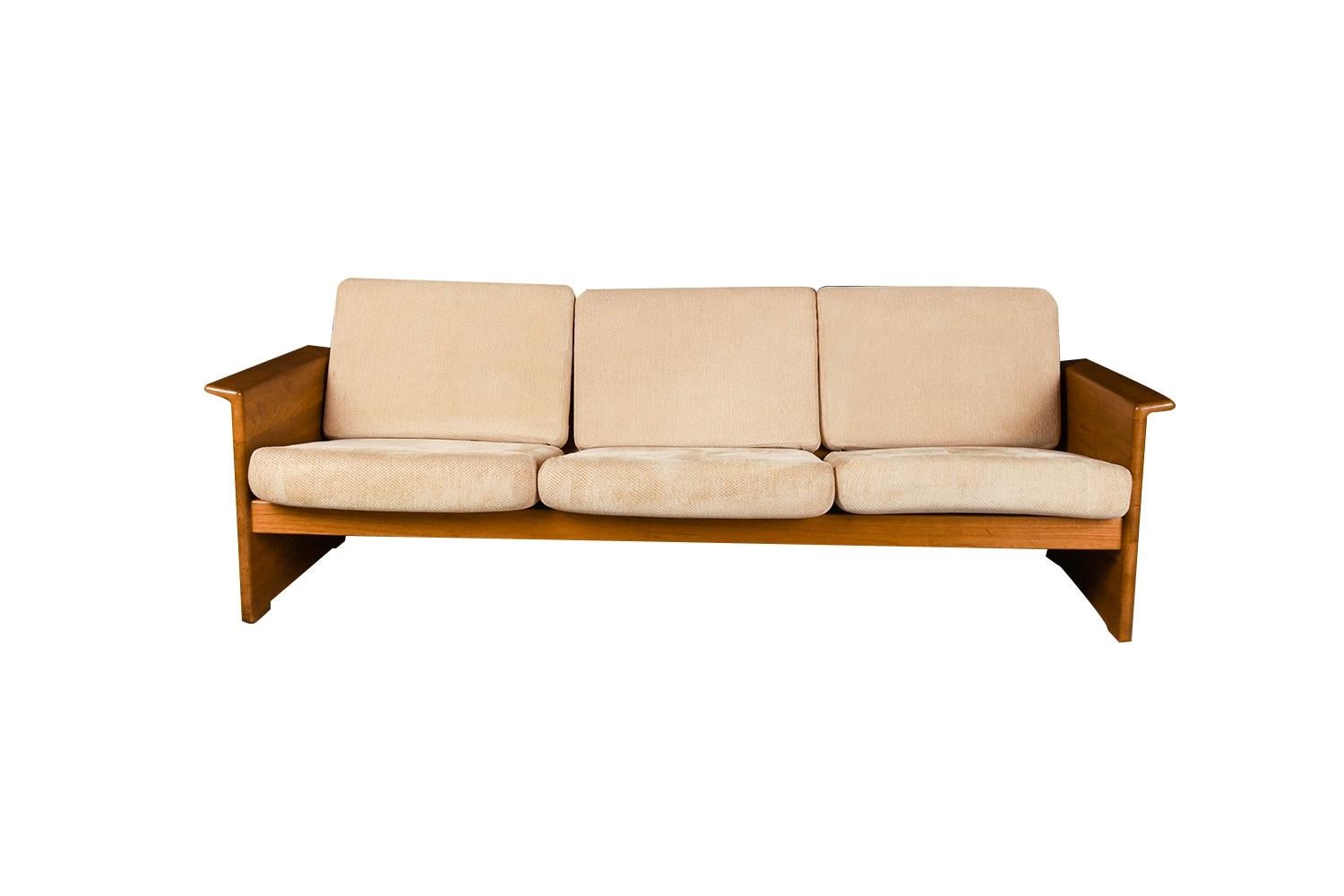 Stunning Mid-Century Modern Danish three-seat sofa, in original soft fabric from Domino Mobler, made in Denmark. An exceptional sofa both for its form and quality, it is a distinctive and heavily crafted work of rectangular form with curved arms and
