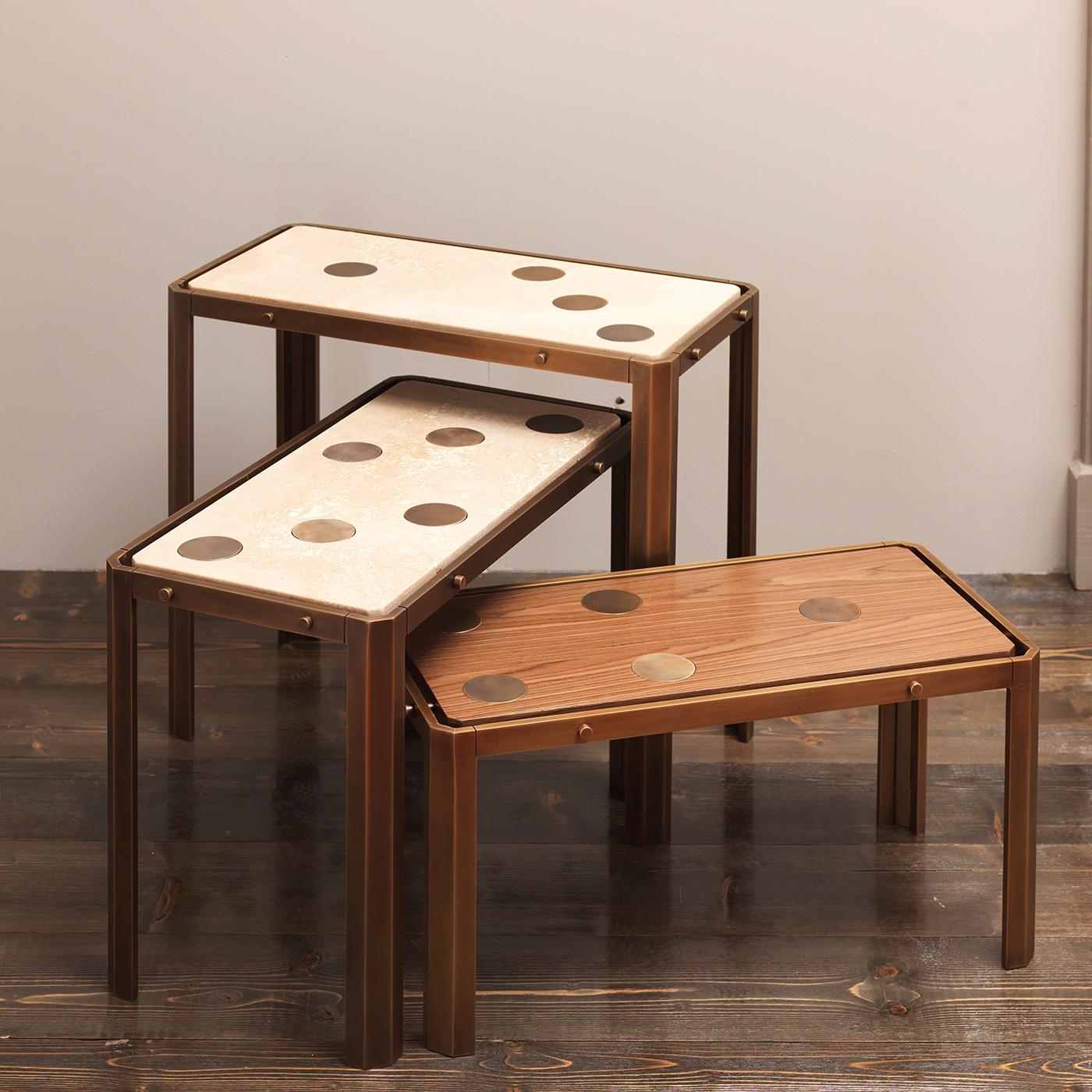 Designed by Ciarmoli Queda Studio and part of the Domino Collection, this elegant and playful set of three side tables is a versatile and eye-catching choice for a modern home. The wooden structure boasts visible brass hardware on the sides of the