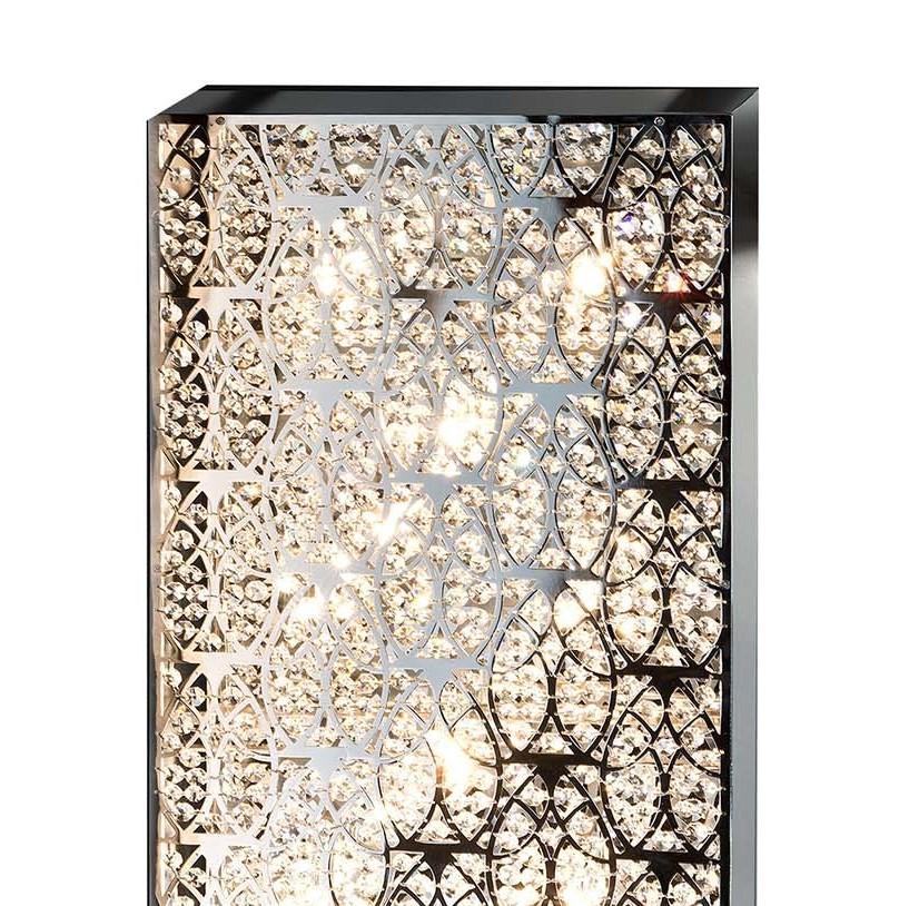 This elegant wall lamp will be a superb addition to a modern interior, enlivening the texture of a wall in a living room or entryway. The rectangular silhouette of this piece is made up of sinuous steel elements creating a luminous sense of movement