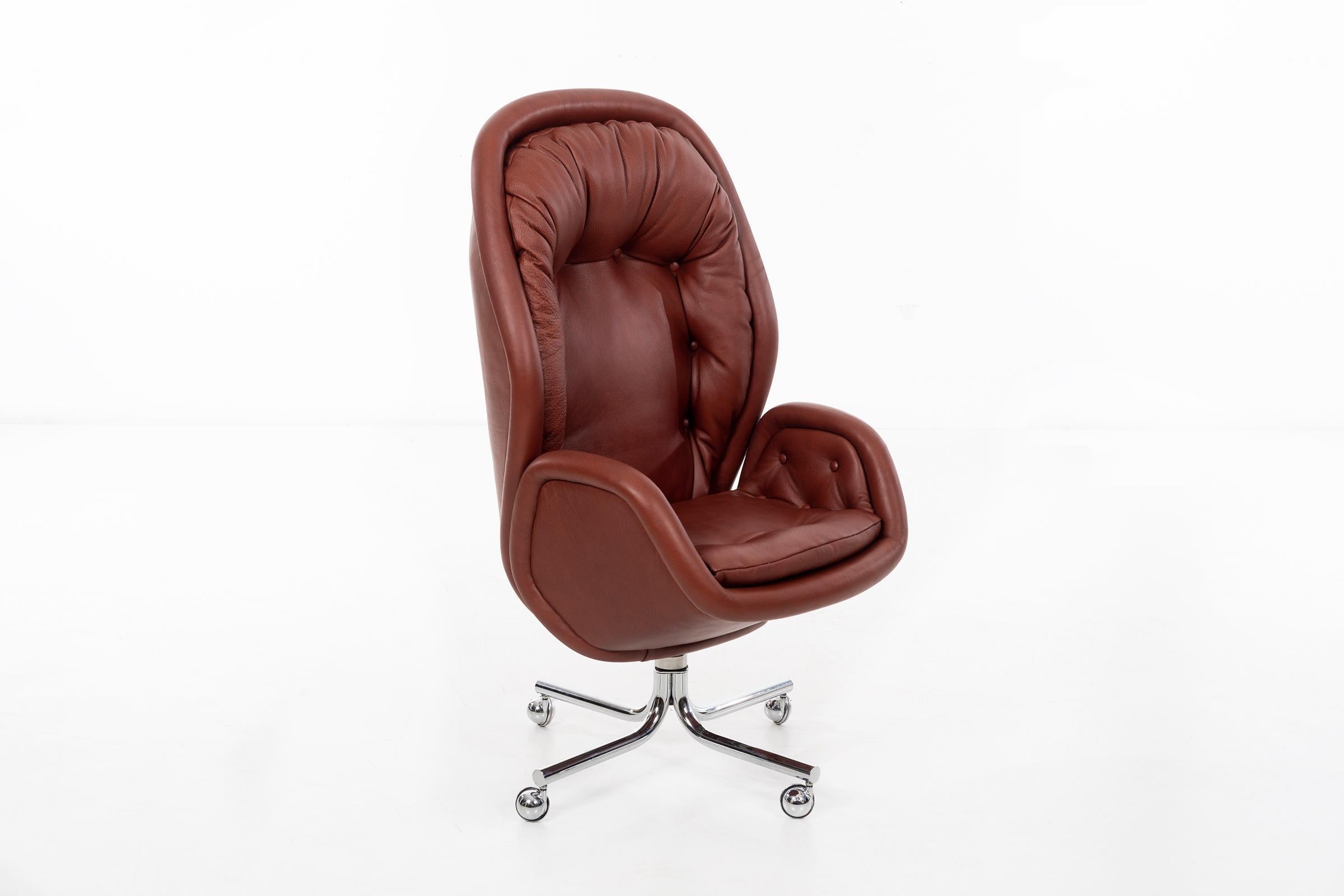 Sculptural executive desk chair. Newly upholstered with foam in Spinneybeck leather, on chrome-plated base. Chair features adjustable height, swivels, and reclines.
