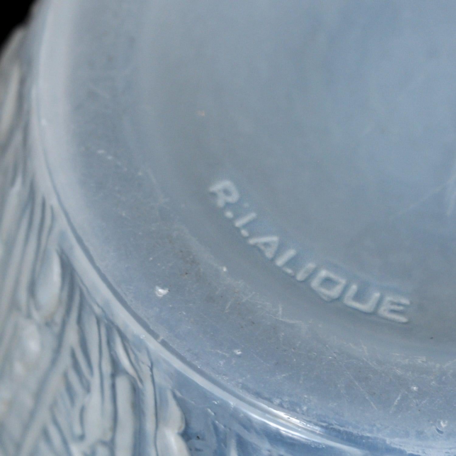 An Art Deco Domremy design vase by Rene Lalique (1860-1945). Souffle mould opalescent glass vase with stylised thistle design. Rim re-polished.

R Lalique embedded to base

Literature: Marcilhac Catalogue Raisonné de L’Oeuvre de Verre p.434.
