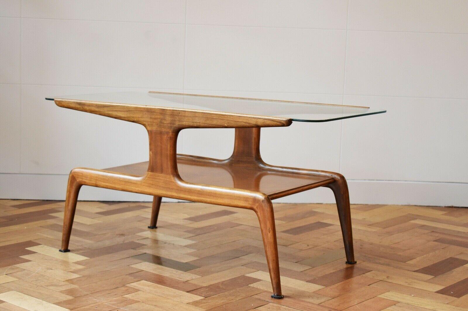 Very rare sculptural Domus Nova coffee table designed by Gio Ponti and manufactured by Domus Nova for the store ‘La Rinascente’, Italy 1950.
This table is made of walnut wood and gas a glass top. There is a pattern on the lower part of the table,