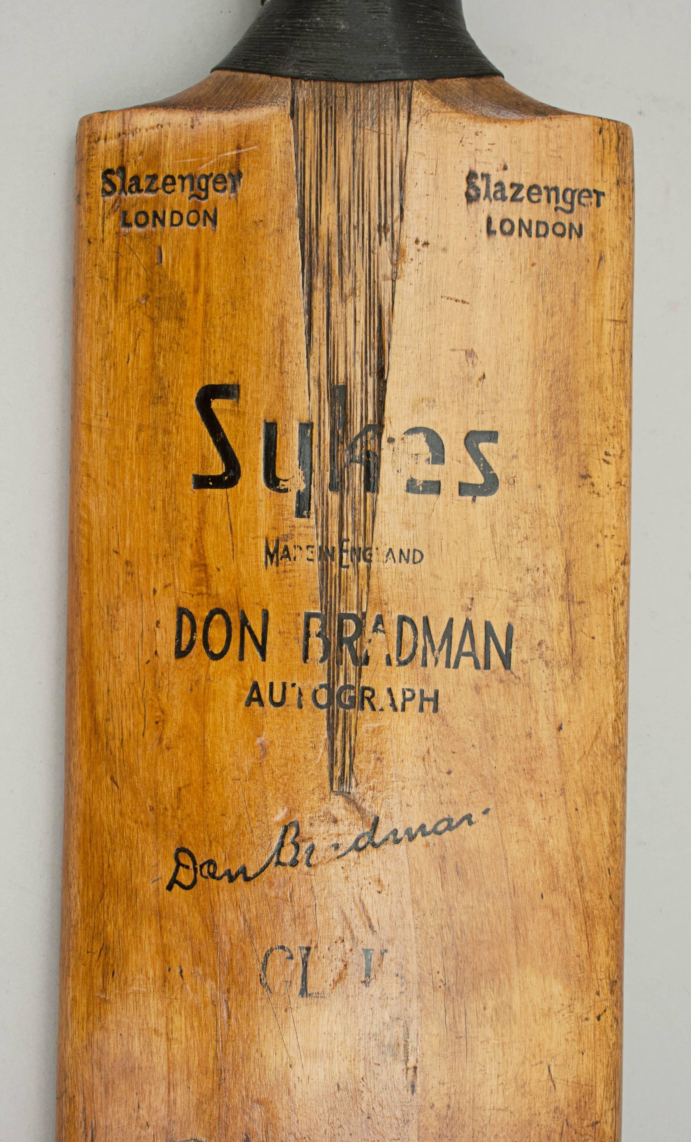 Sykes, Bradman cricket bat.
A fine Sykes 'Don Bradman' autograph cricket bat. The blade is clean and in good condition with a cord strung grip and triple sprung handle. The shoulders are embossed 'Slazenger' London, the blade with a facsimile