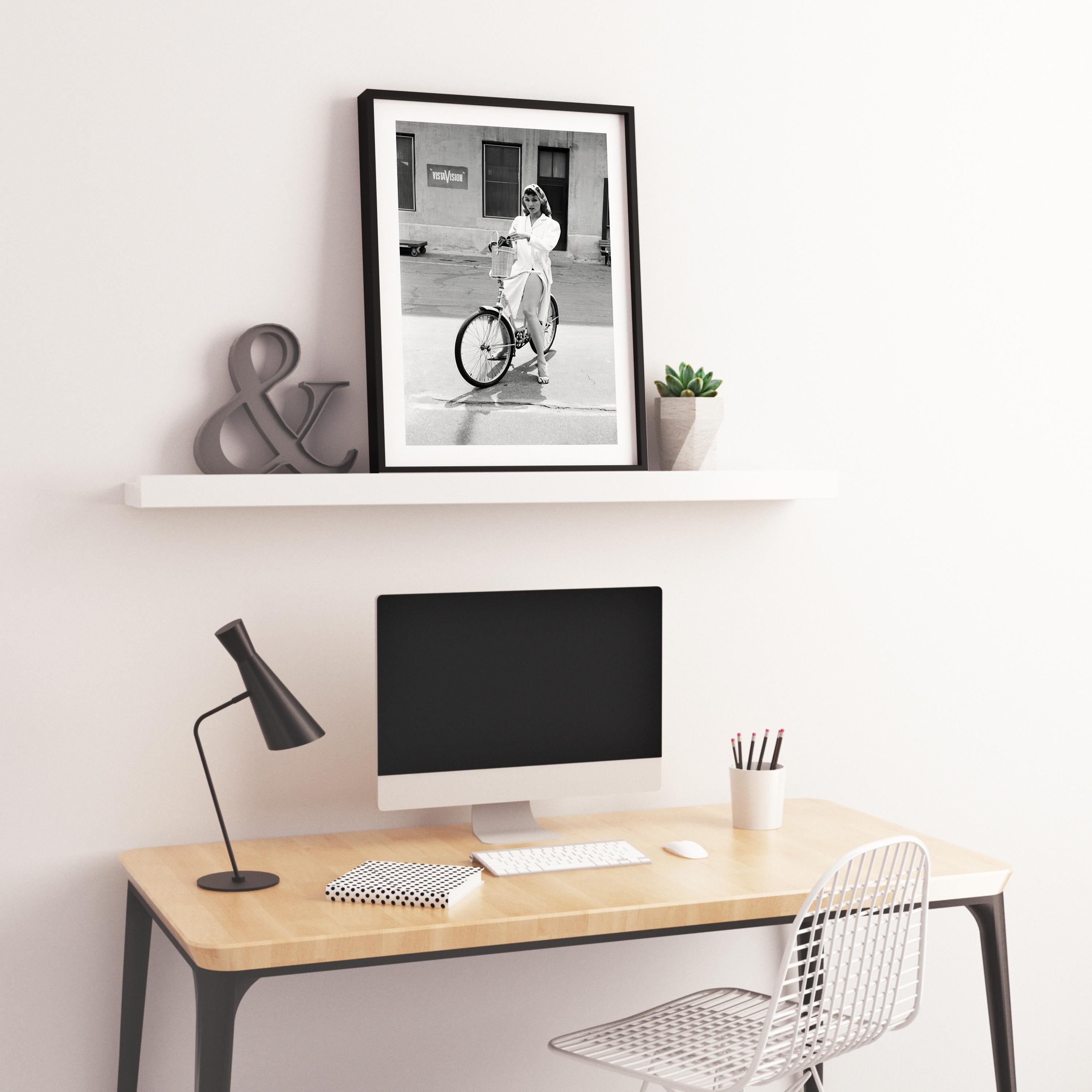 Julie Newmar on Bicycle Fine Art Print - Gray Black and White Photograph by Don Ornitz
