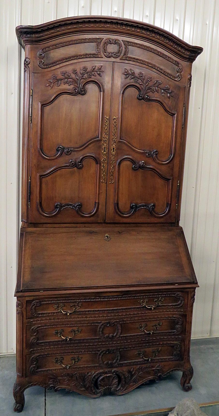 Don Rousseau country French secretary desk with 3 shelves behind 2 doors, leather top writing surface that encloses 3 drawers, and 3 drawers at the bottom.