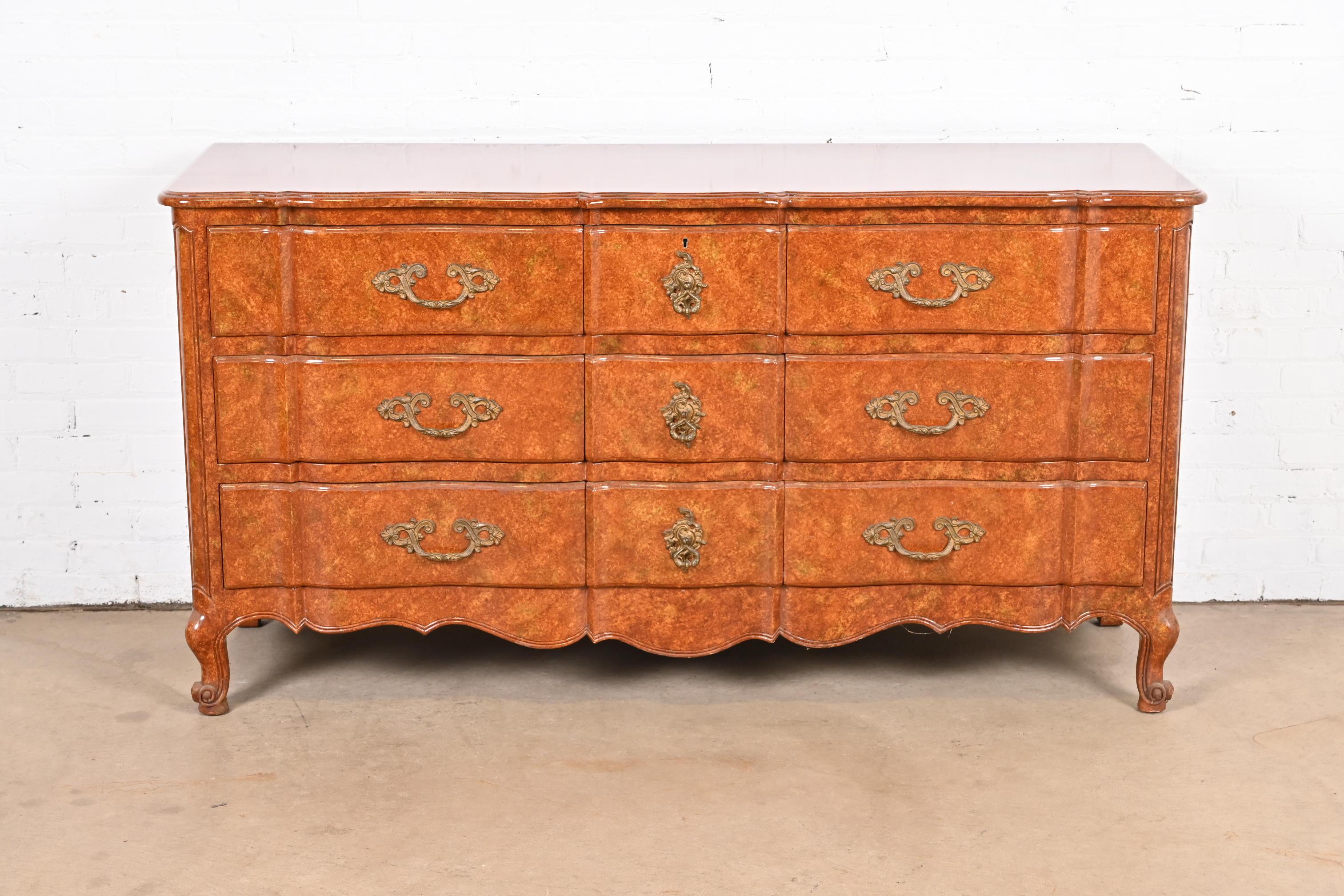 A gorgeous French Provincial Louis XV style triple dresser or credenza

By Don Ruseau

USA, Late 20th Century

Solid walnut in faux burl painted finish, with original brass hardware.

Measures: 65.75