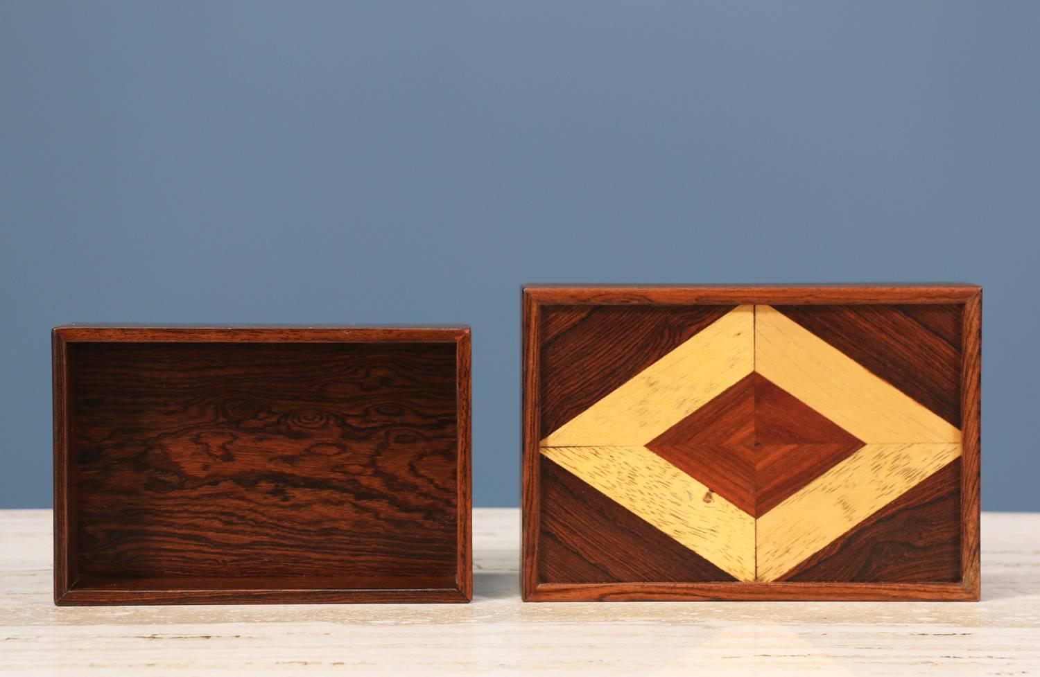 Decorative box designed by Don S. Shoemaker for Señal Funiture in Mexico circa 1960’s. This Mexican modern box features a rosewood body with a beautiful diamond shaped oak parquetry adorning the top of the box.