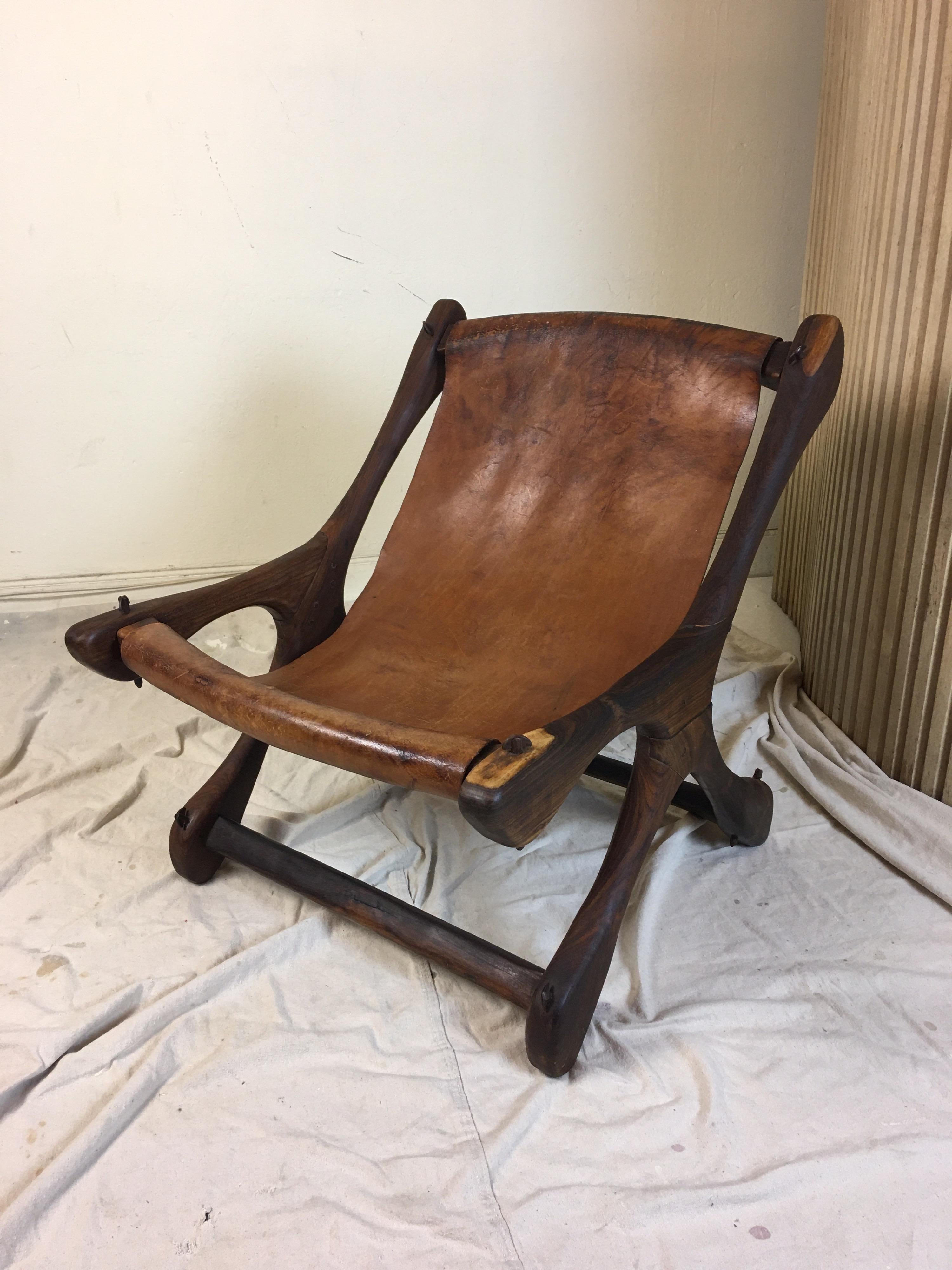 Early Don S. Shoemaker solid rosewood lounge chair. Dowels are unusual and more substantial than later models. Sling is also 1 piece of Leather instead of the pieced together covers. Very solid chair, with beautiful original finish throughout!