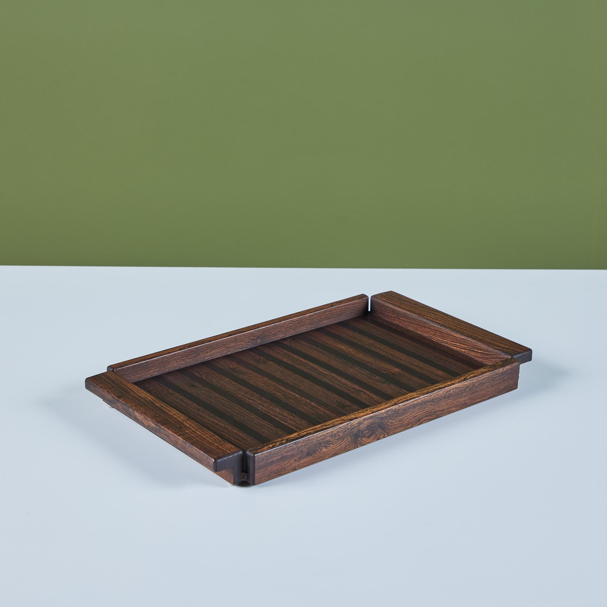 Cocobolo tray by Don Shoemaker for Señal, Mexico, c.1960s. The tray has a Cocobolo frame with integrated handles and features an inlaid striped pattern of rosewood.
Retains original manufacturer’s label on the underside.

CITES Notice: Due to
