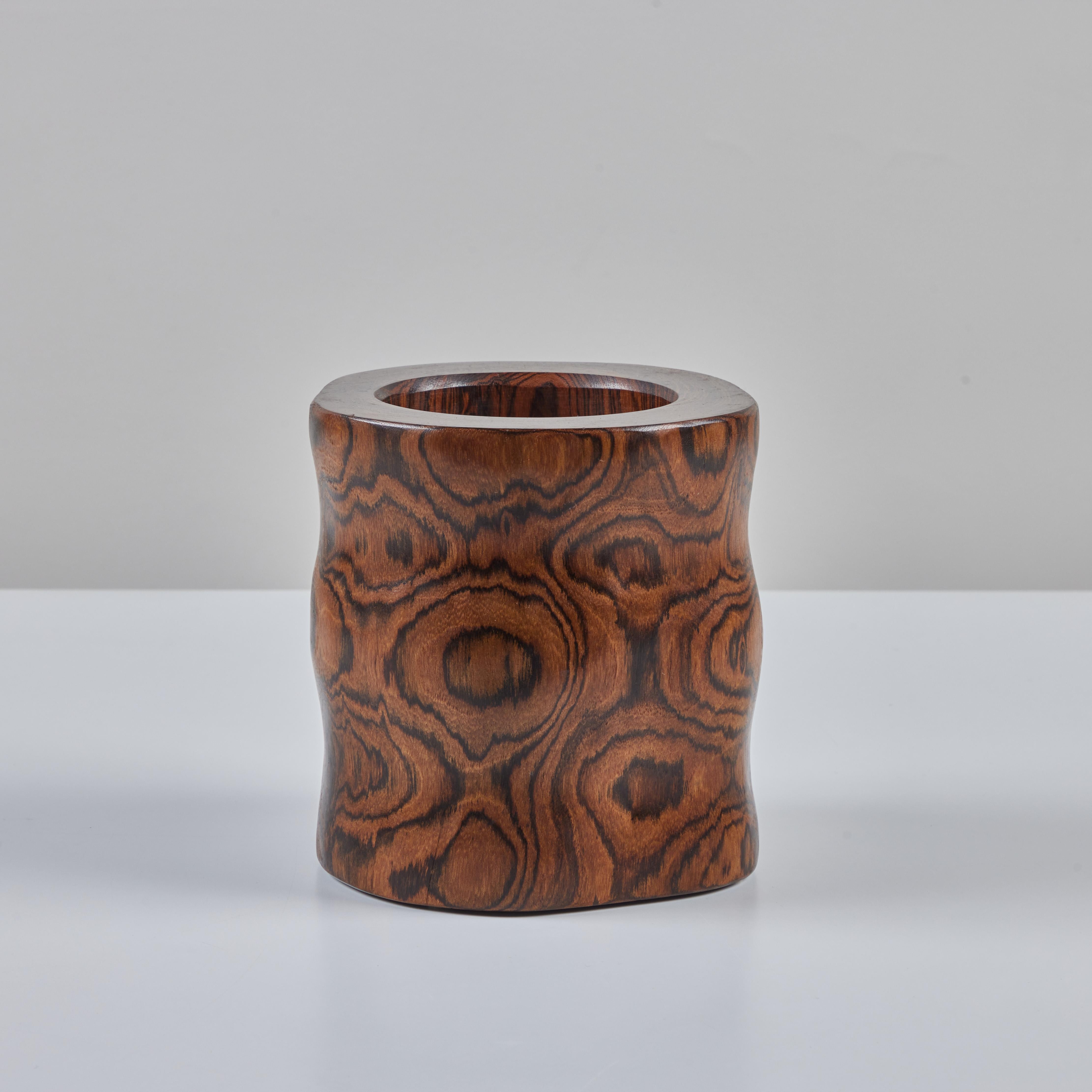 Don Shoemaker Cocobolo vessel for Señal, c.1960s, Mexico. The hand carved minimalist vessel features a rippled body with soft rounded edges and an eye catching wood grain.

CITES Notice: Due to stringent regulations on the export of rosewood