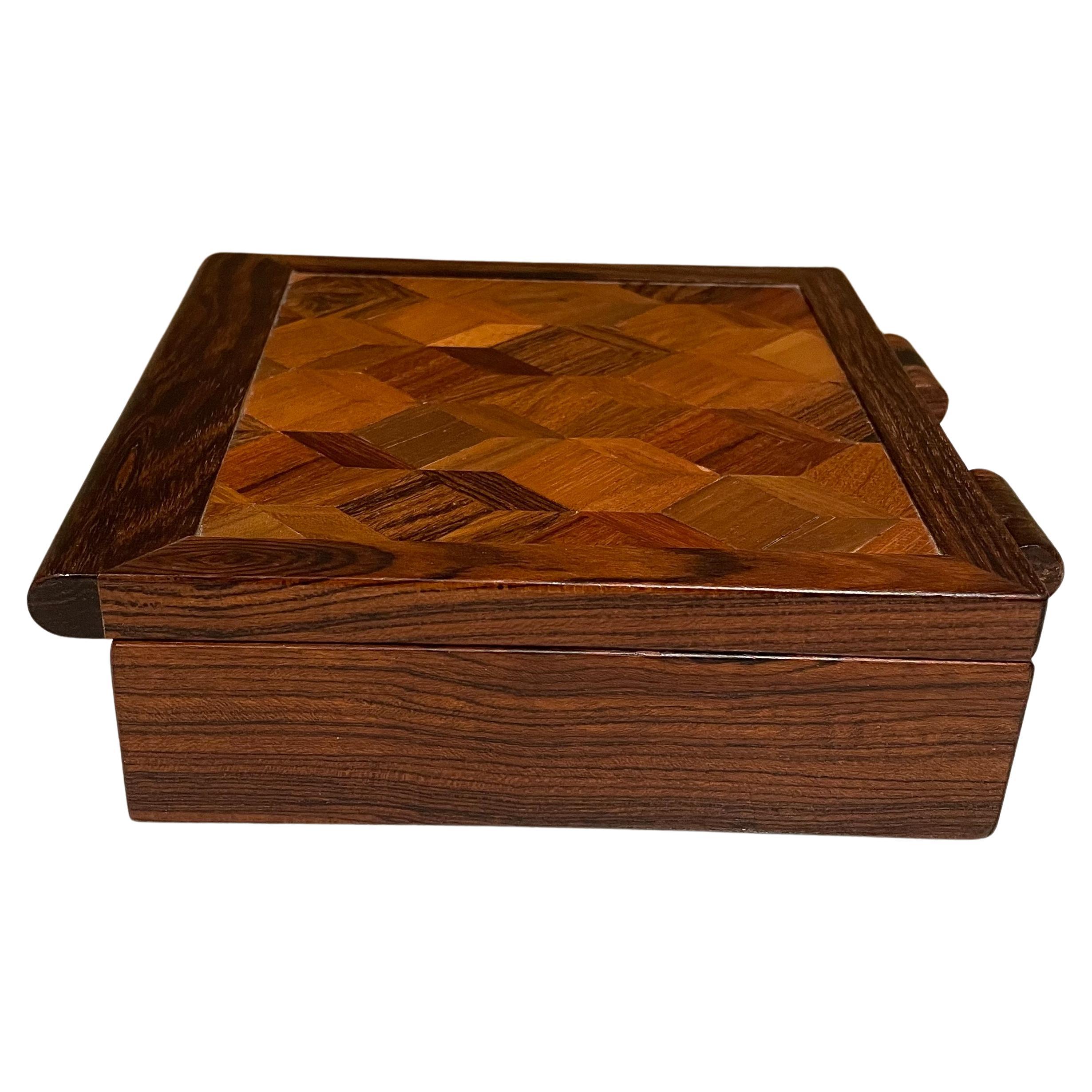 Wood Hinged Box
Cocobolo and Exotic Mosaic Patchwork Small Wood Box by Don Shoemaker for Senal Morelia Mexico
Refined wood hinges
Measures: 7.5 D x 5.75 x 2 H, inside 4.75 x 4.75 x 1.13 H
Original preowned vintage condition.
Refer to images