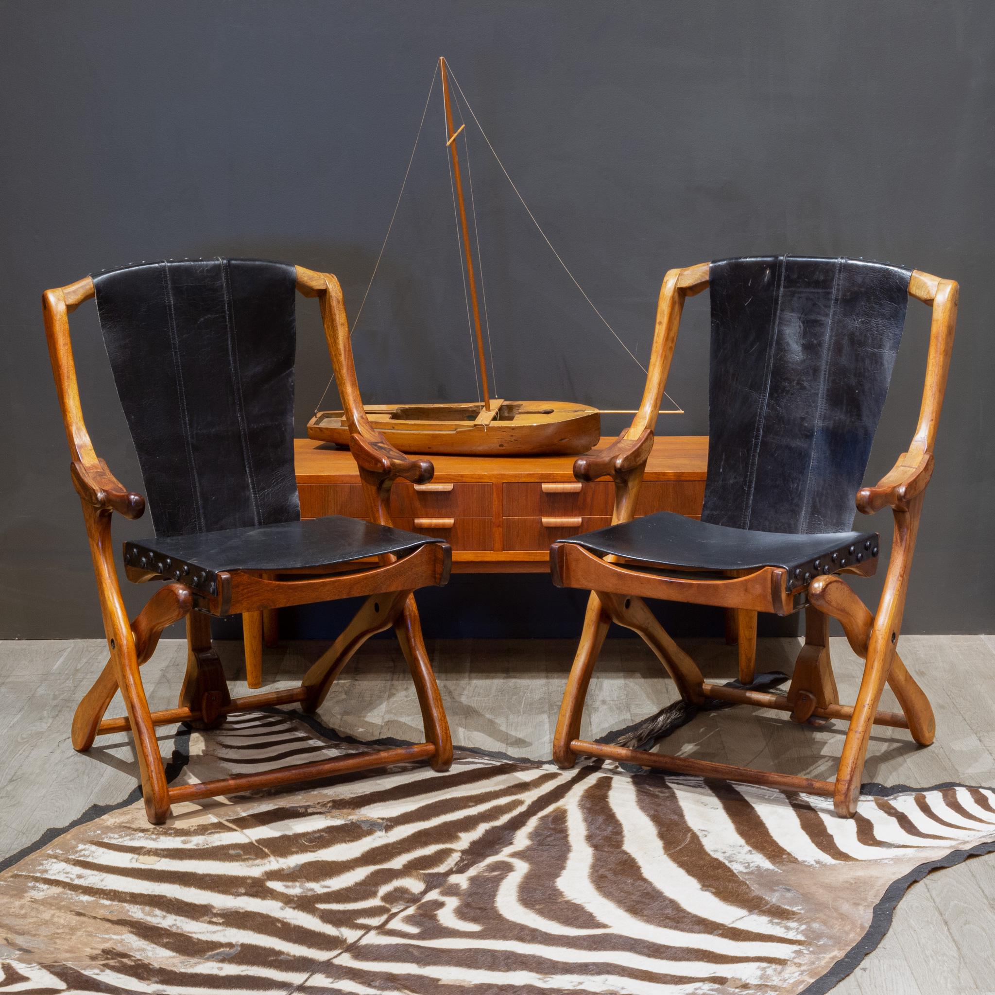 ABOUT

Price is per chair. Four available. 

Original folding lounge chairs designed by Don Shoemaker for Senal SA. The chairs are made out of Cocobolo Rosewood and upholstered in the original black leather with decorative leather pins on the top
