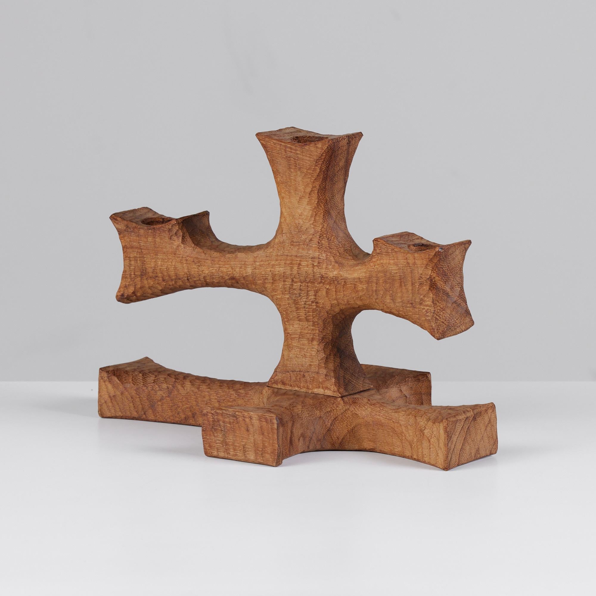 Don Shoemaker for Señal hand carved candelabra. Carved out of mahogany and left as bare wood, this piece holds three standard size candles. The carving marks, opposite in direction from the wood grain, give it texture and movement. The shape of the
