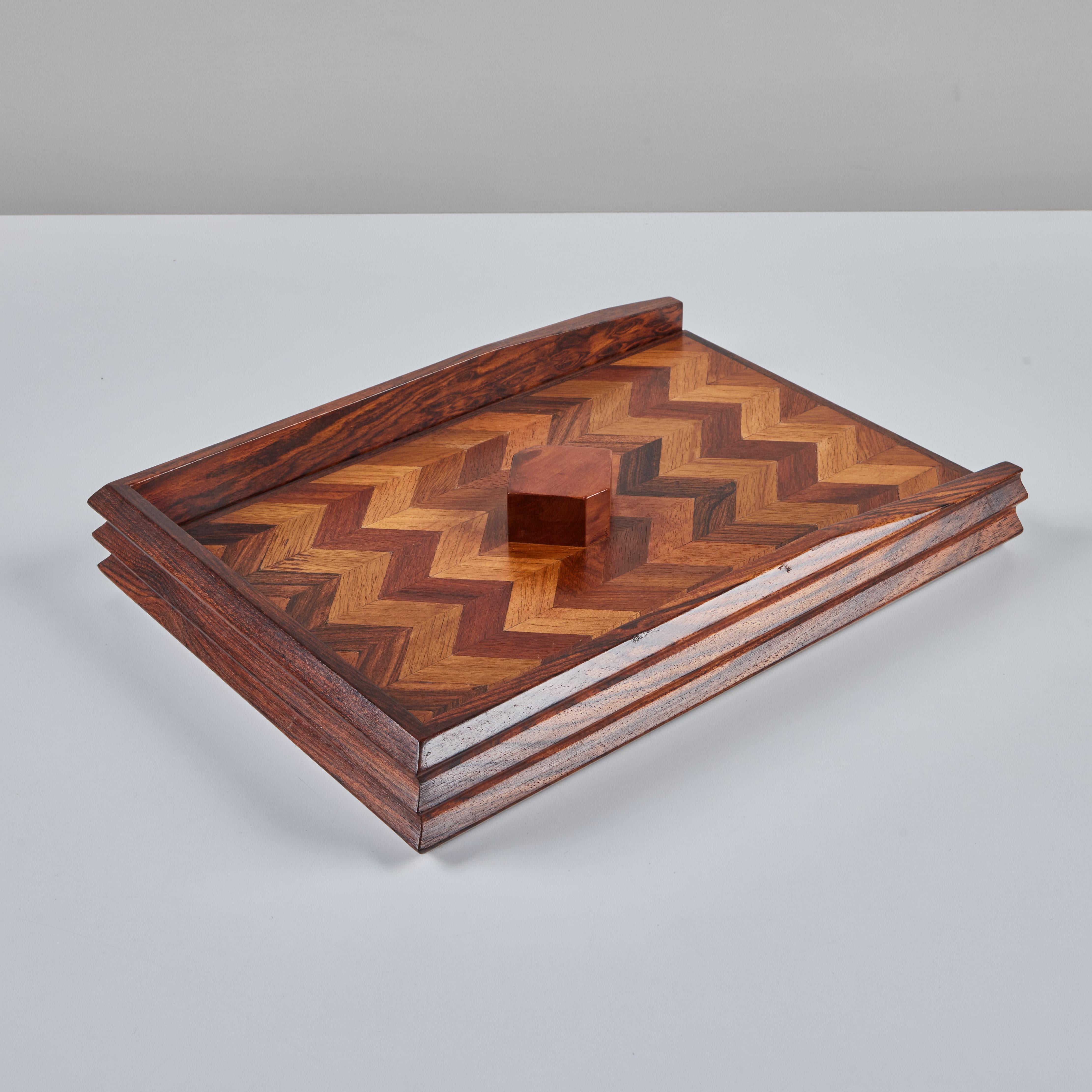Cocobolo paper tray with geometric pattern by Don Shoemaker for his company Señal, c.1960s, Mexico. Shoemaker is known for the marquetry in his work, which is clearly visible in the detailed design of this piece. The lid of the tray has a chevron
