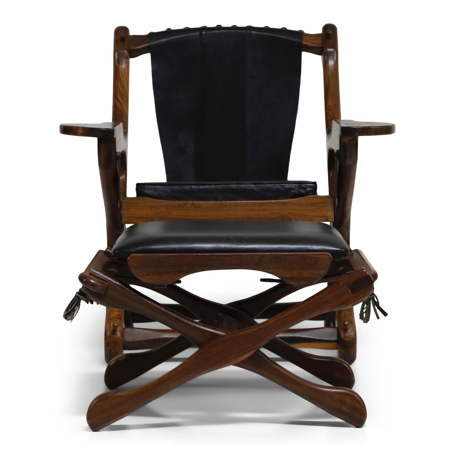 Named the 'Swinger Chair' for its pivoting mechanism that allows you to swing in your seat, this incredible Cocobolo Rosewood and black leather 'Swinger' chair with matching ottoman by leading 1960s modernist designer Don Shoemaker for Senal S.A.
