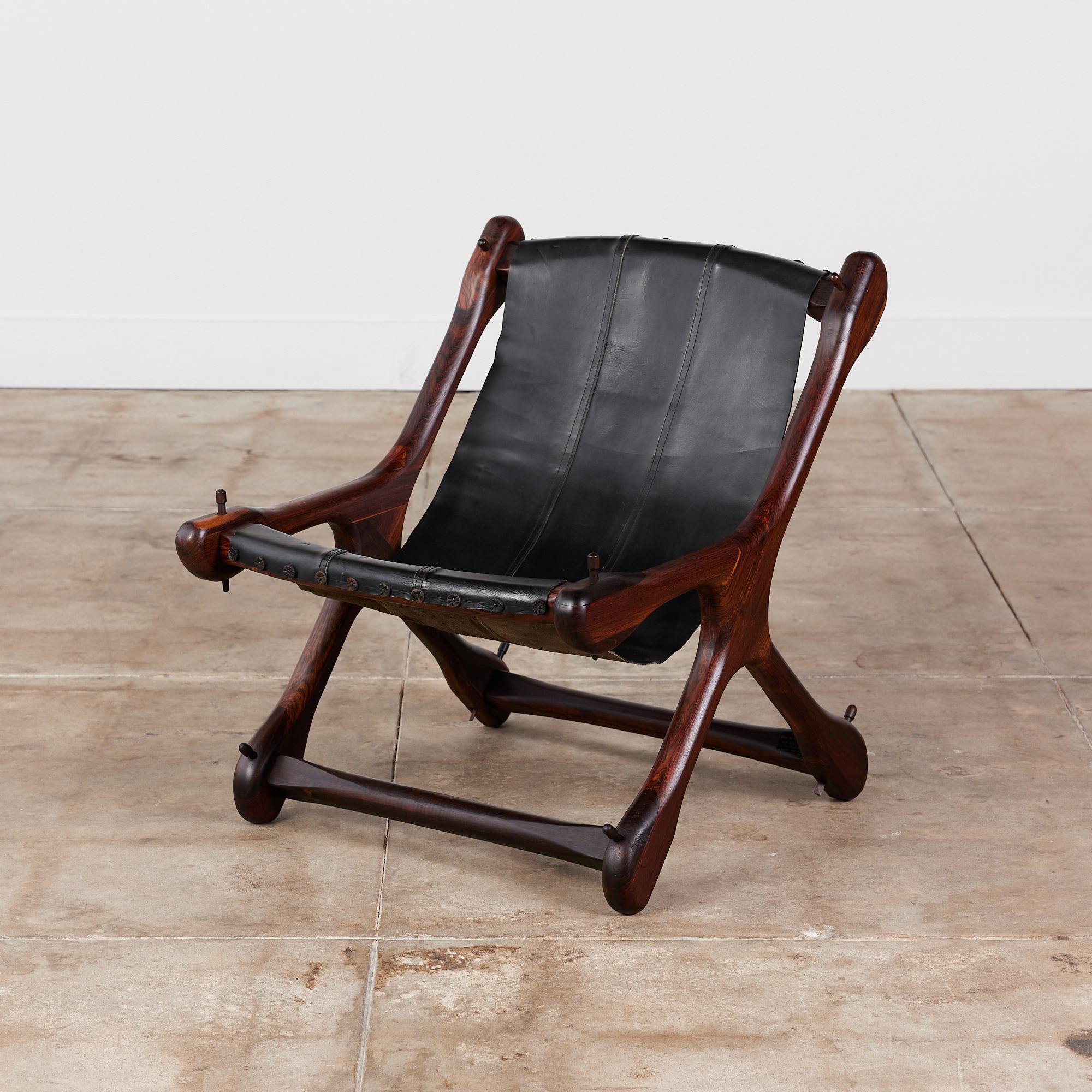 Leather lounge chair by Don Shoemaker for Señal, circa 1960s, Mexico. The chair features a rosewood frame and original patinated black leather hide. Leather button and nail details line the front seat of the chair and top of the backrest where the