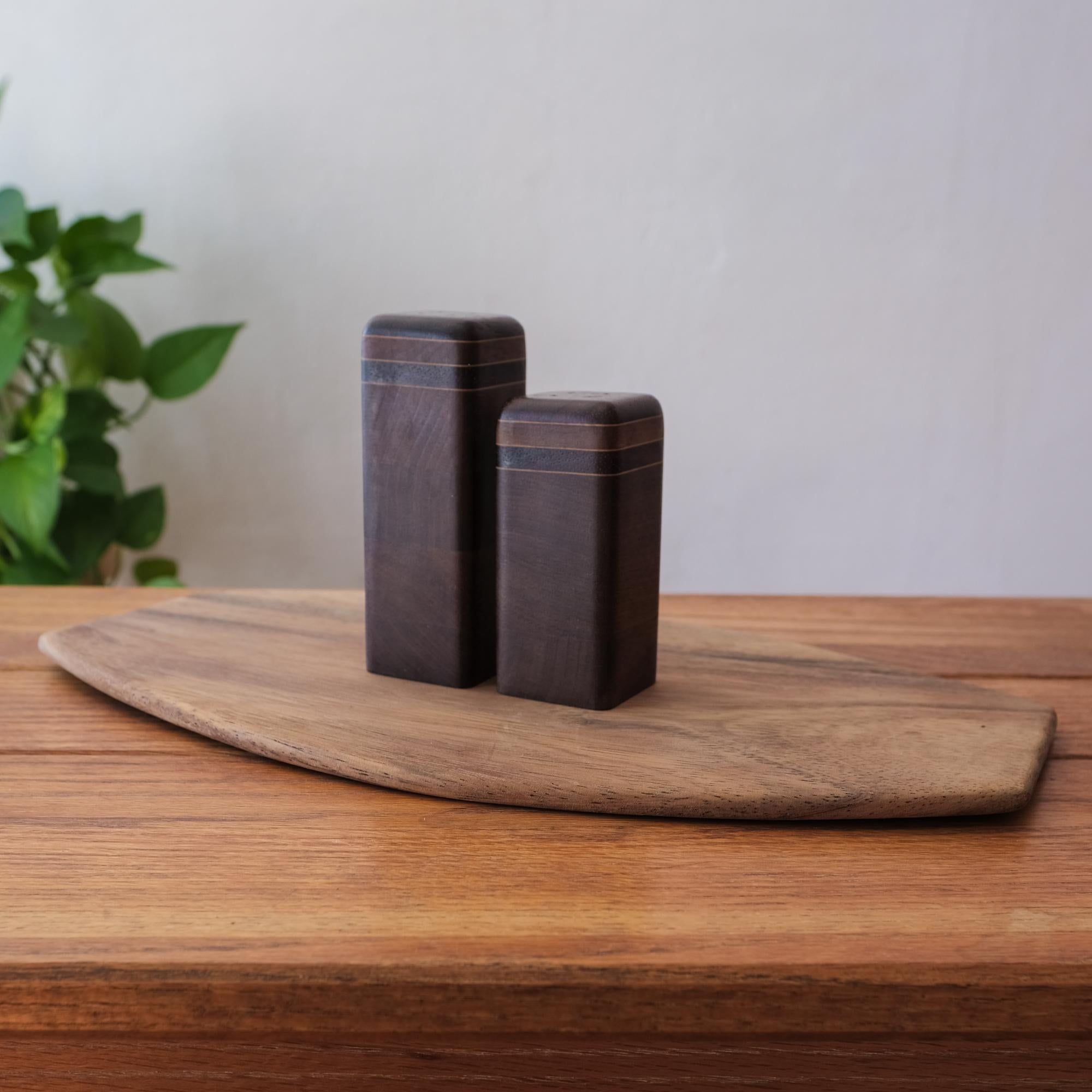 Cutting board or serving tray and mixed exotic woods salt and pepper shakers by Mexican Modernist Don Shoemaker. Retains original label from his workshop in Señal Mexico.