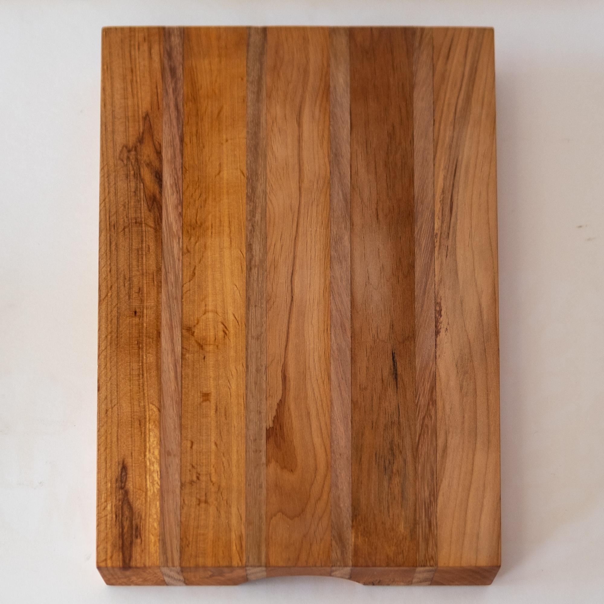 Unused mixed wood cutting board or serving tray by Mexican Modernist Don Shoemaker. Retains original labels from his workshop in Señal Mexico.