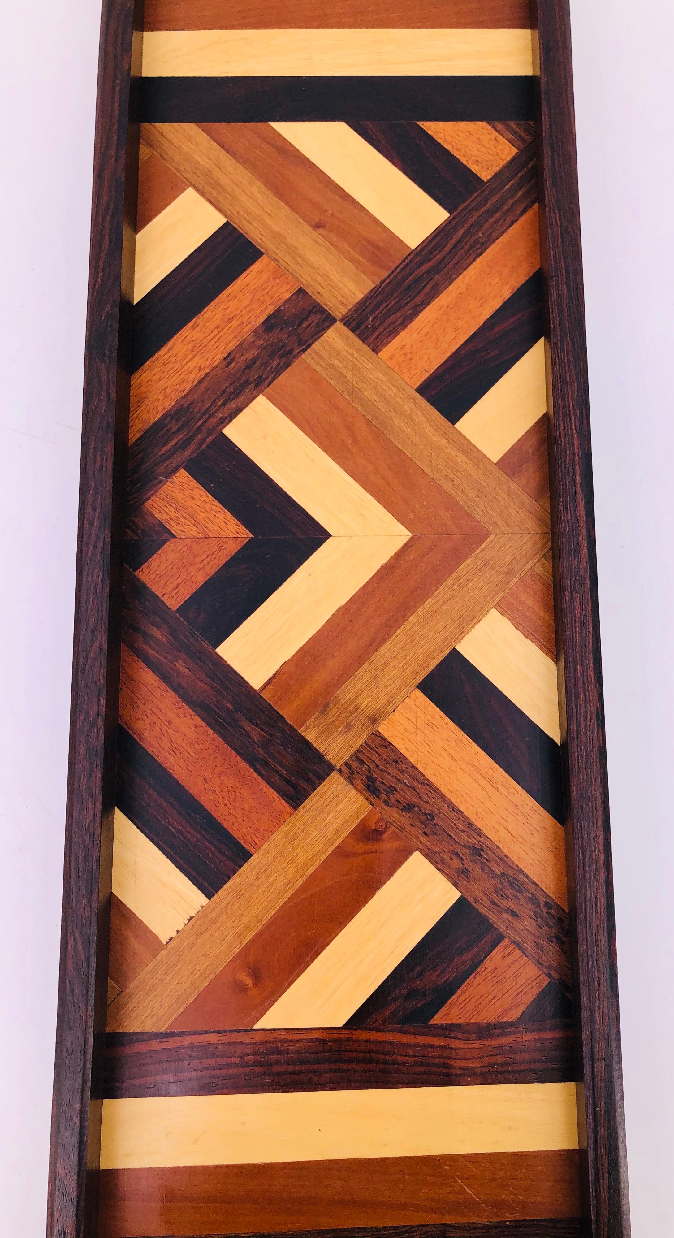 A beautiful example of Don S Shoemaker's incredible design and woodwork for SeÑal. 
This tray has a great shape, profile, and mix of inlaid woods including cocobolo, rosewood, jacaranda, mahogany, etc. The tray has an original Senal label and