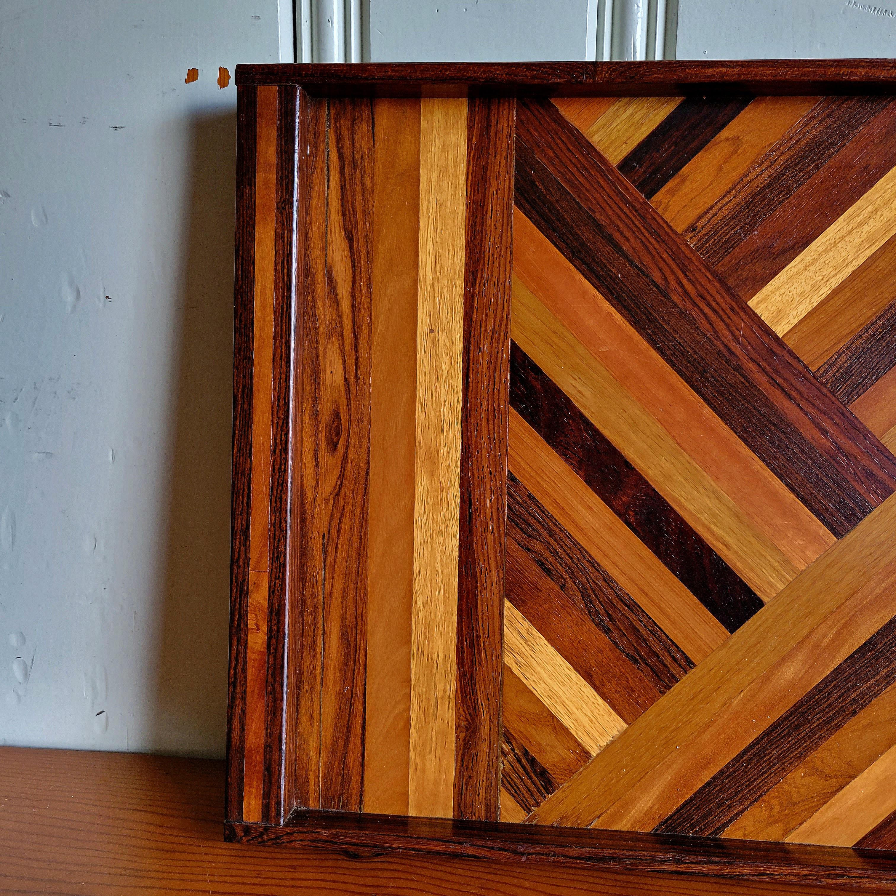 Don Shoemaker was an American ex-pat who moved to Mexico and started a huge furniture manufacturing facility that is still running to this day. 

This a more obscure large version of the tray. Comprised of multiple species of exotic woods cut at