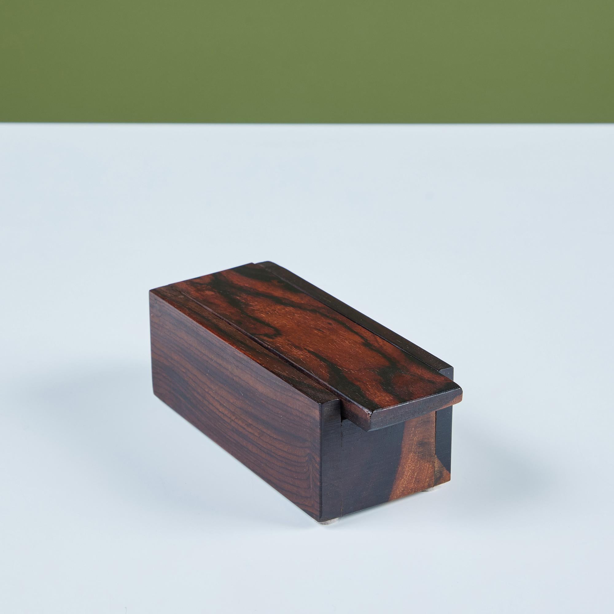 Rectangular Cocobolo box by Don Shoemaker for his company Señal, c.1960s, Mexico. Shoemaker is known for his use of exotic Mexican hardwoods and this hinged lid box is a beautiful example of his work.

Dimensions
5.75” width x 2.5” depth x 2”