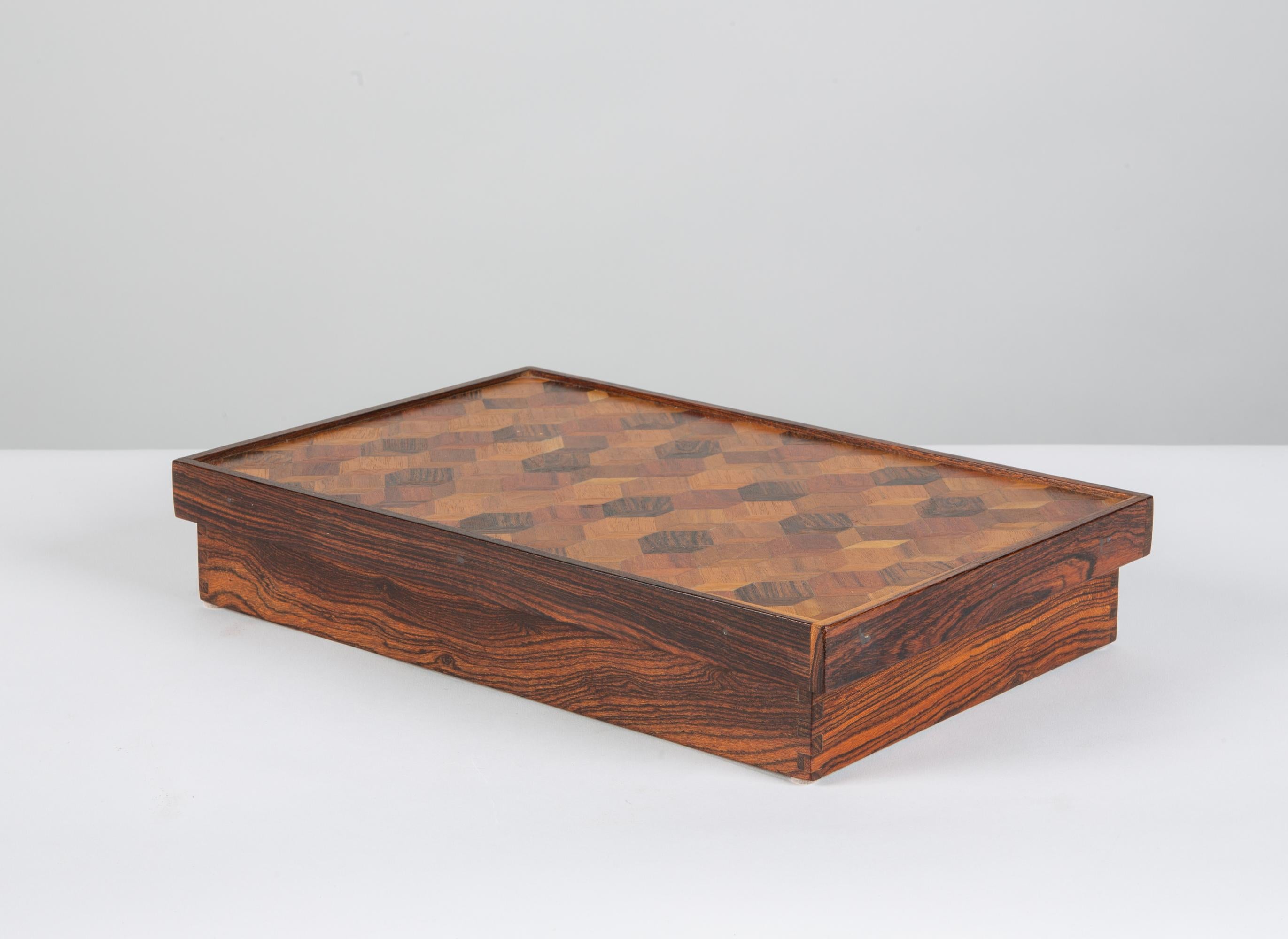 A rectangular Rosewood box with geometric pattern by Don Shoemaker for his company Señal, c.1960s, Mexico. Shoemaker is known for the marquetry in his work, which is clearly visible in the detailed design of this piece. The top of the box has a