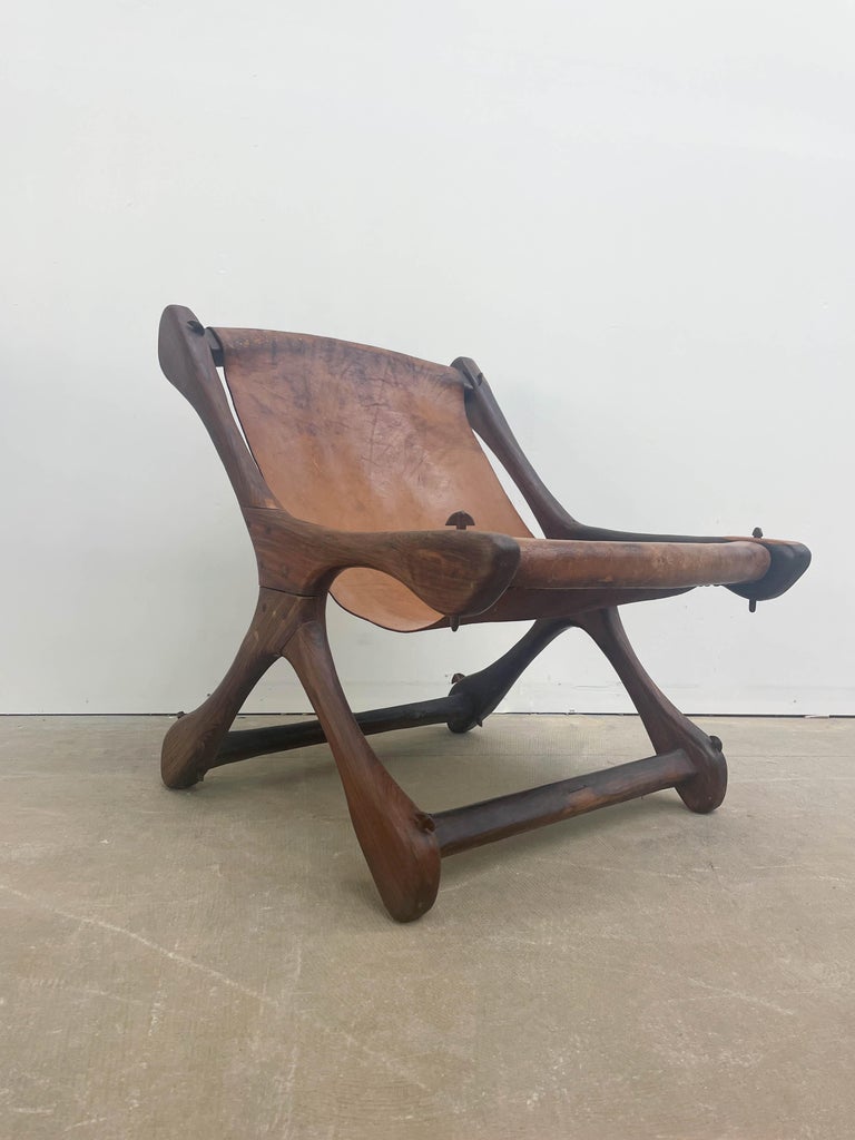 Solid Brazilian Rosewood lounge chair designed by Don Shoemaker in the 1950s. Unique organic forms and a combination of excellent materials provide a special seating experience. The leather sling is original and is worn but in usable shape and