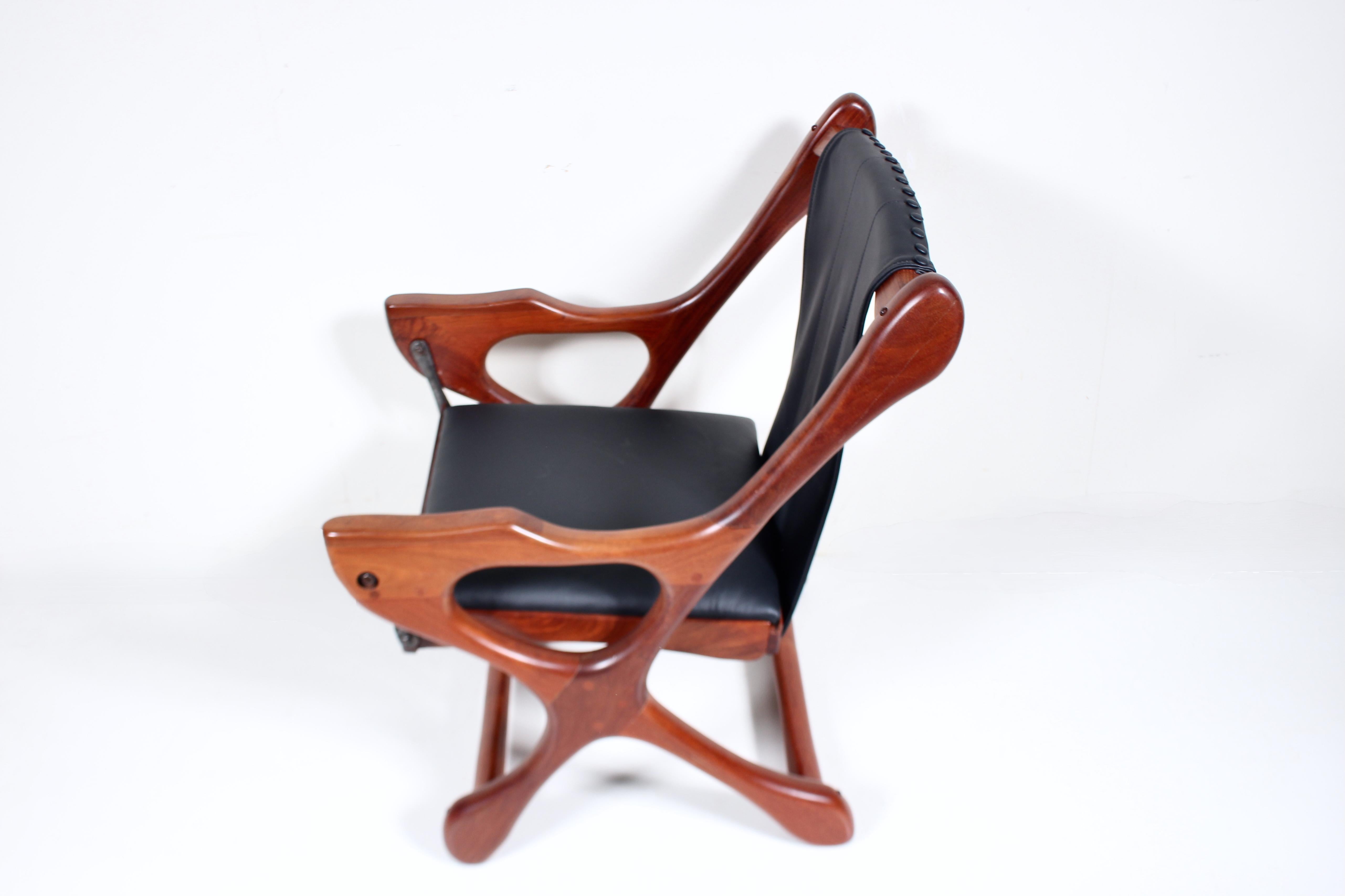 Don Shoemaker for Señal S.A. Bocote & Black Leather Lounge Chair. Featuring handcrafted braced and smooth Mexican Bocote Wood, peg construction, comfortable ergonomic Sling, newly upholstered and cushioned Black Leather. Front of Arms 21.75H. Front