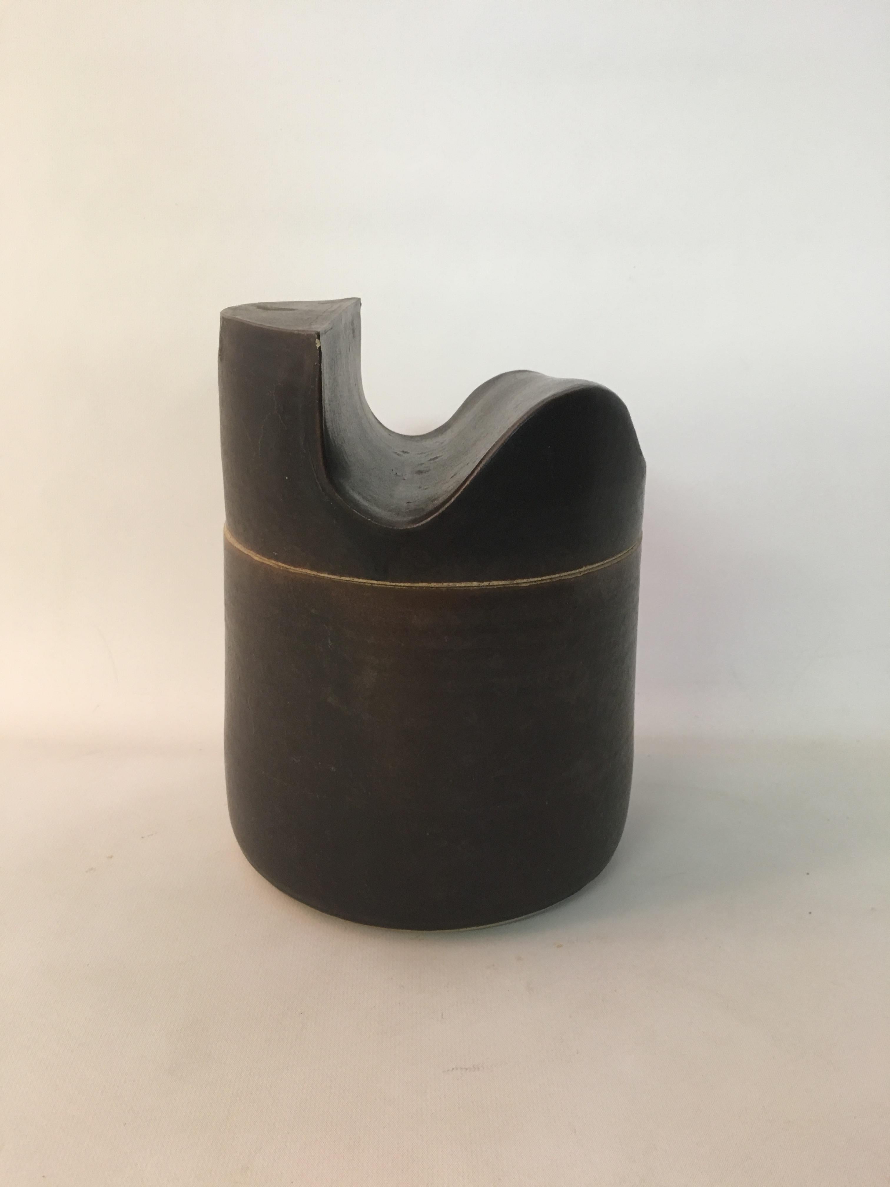Don Williams designed hand built ceramic covered jar, circa 1980-1990. Handmade and glazed in a matte brown. Supple, lyrical, architectural, curvilinear design. Fully signed on the bottom, D. Williams.

 