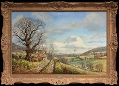 Magnifique grande peinture à l'huile représentant un paysage de campagne britannique avec une petite maison au toit de chaume