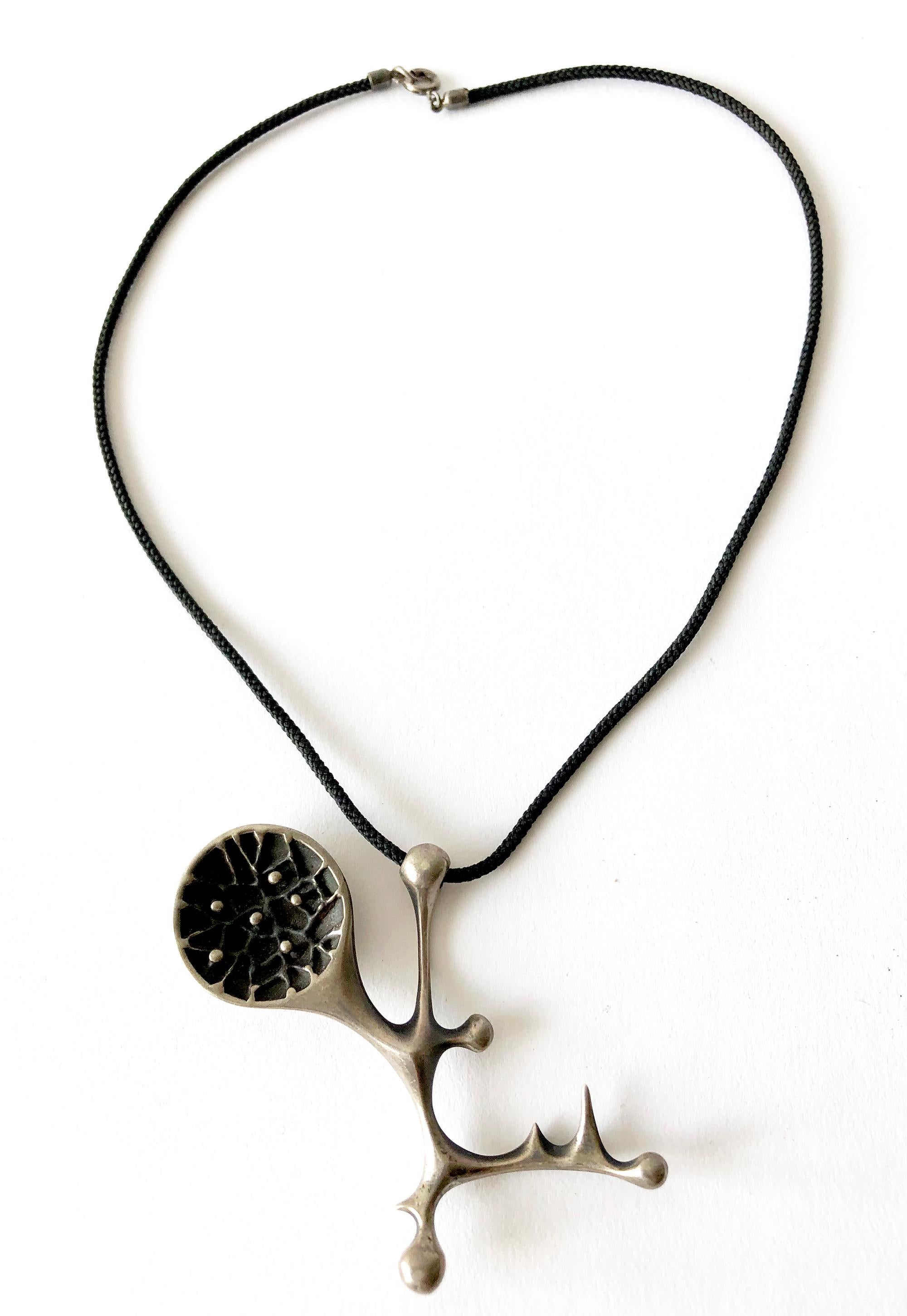 Cast sterling silver abstract modernist pendant created by Donald B. Wright, circa 1950s.  Pendant measures 2.25