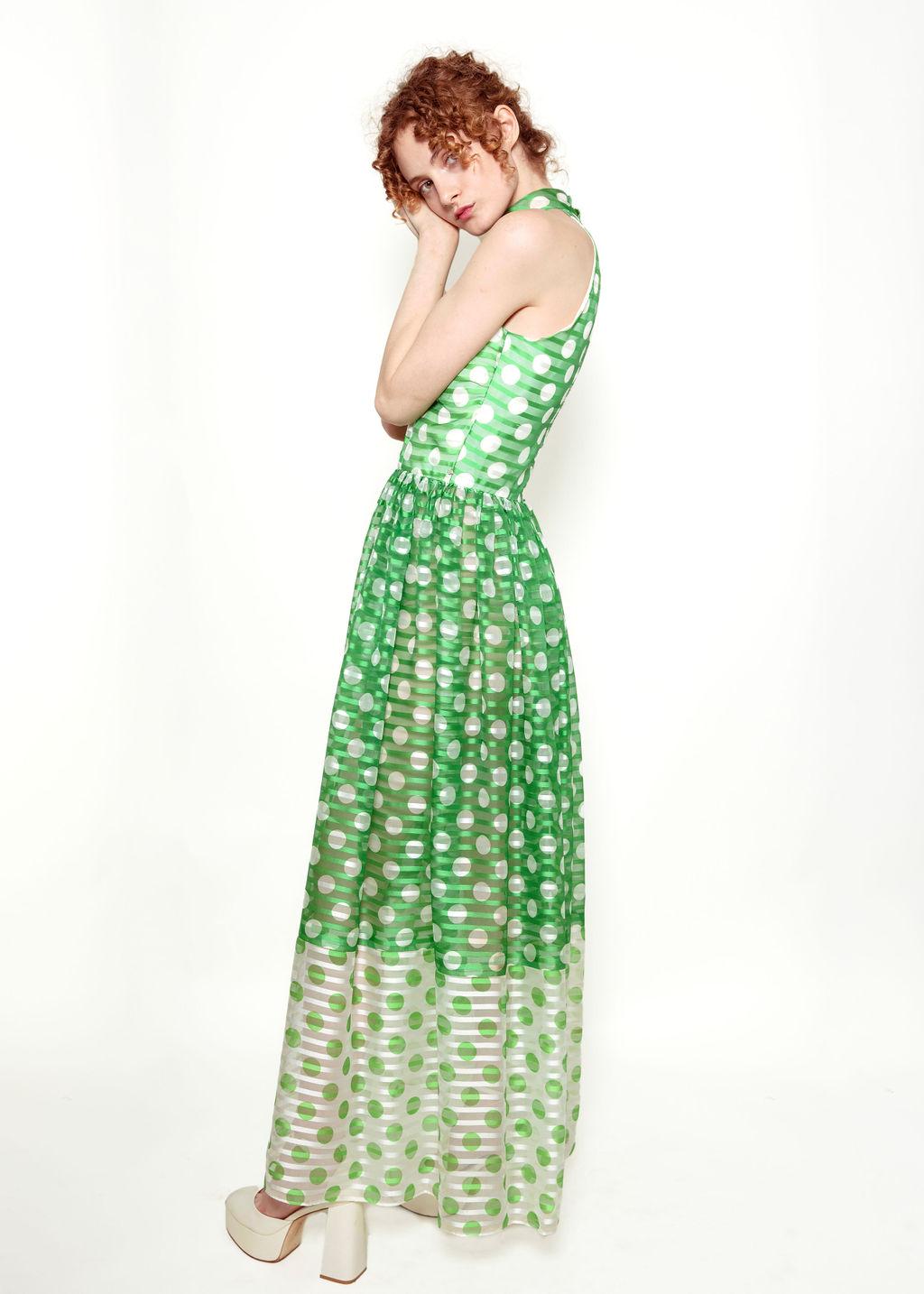  Light up the room with this beautifully vibrant Donald Brooks dress.

The dress has a fully lined bodice and a sheer skirt. With its playful mix of apple green with white polka dots, this dress will have you looking (and feeling!) oh so chic. There