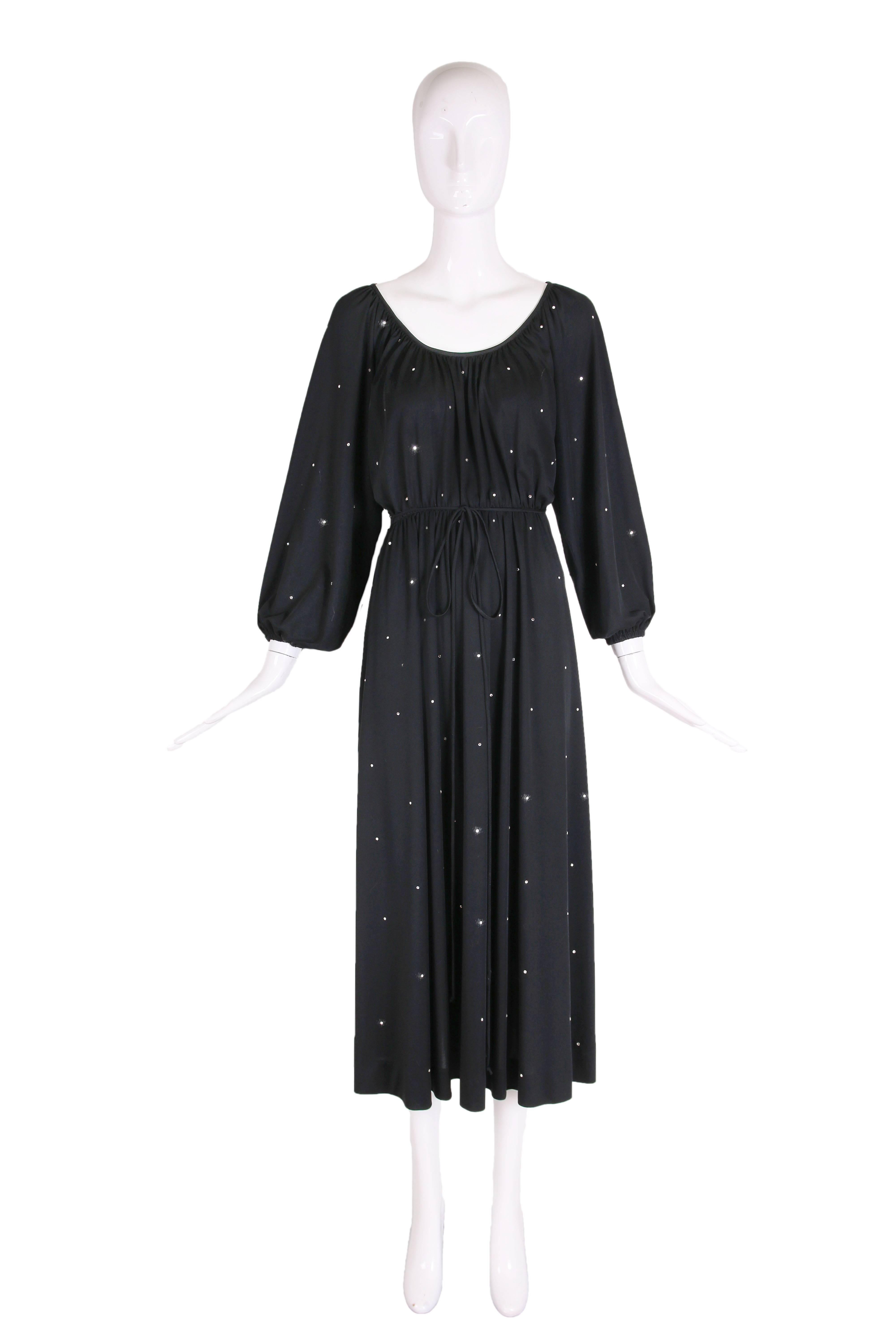 1970's Donald Brooks black jersey disco dress with rhinestone embellishments, subtle balloon sleeves, scoop neck, gathered waist, jersey string waist ties and a back zipper closure. In excellent condition. No size tag, please consult measurements.