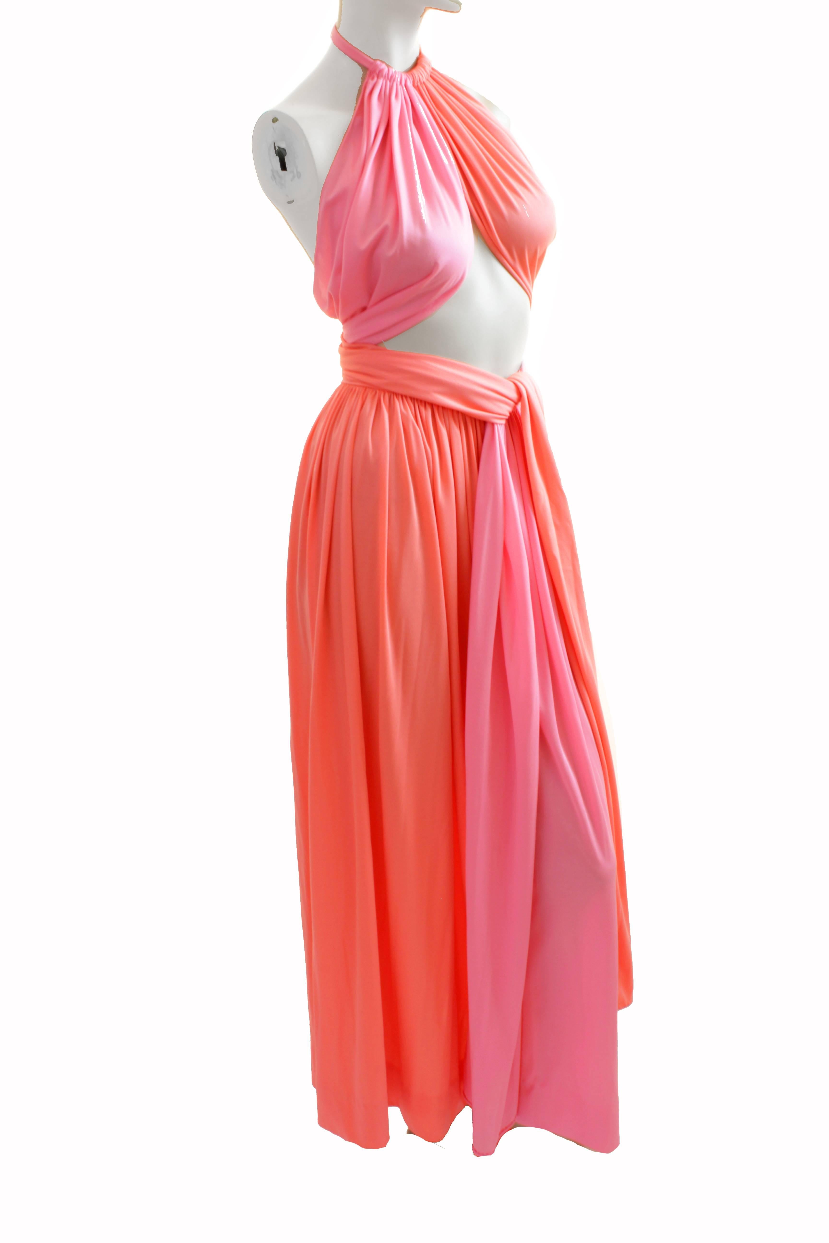 This fabulous two piece halter top and skirt ensemble was made by Donald Brooks Boutique, most likely in the early 1970s.  Made from a color block sherbert pink and melon silky jersey fabric, it features a cool tie-wrap halter top that can be