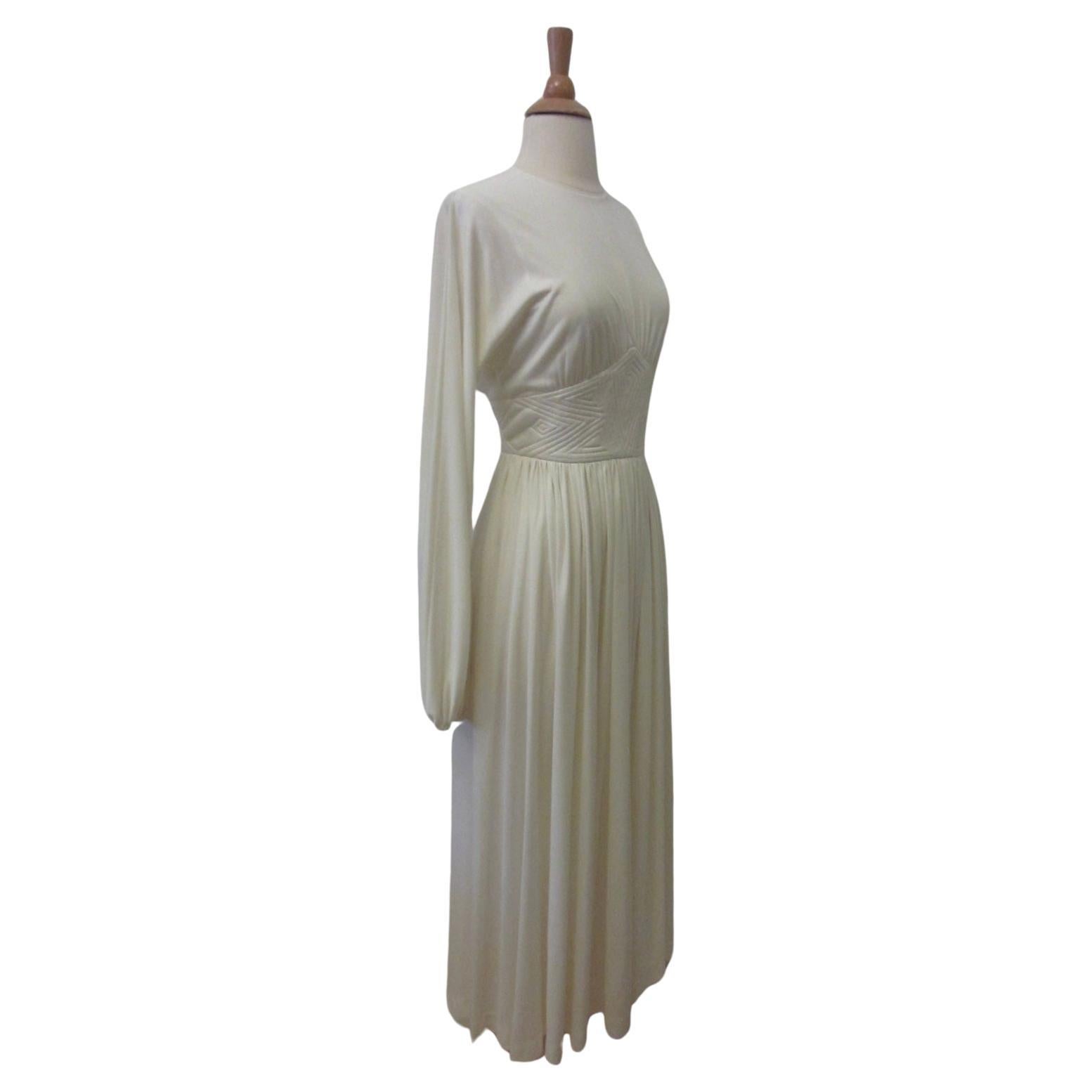 The most beautiful vintage ivory white jersey dress by Donald Brooks. Round collar. Trapunto quilted waistband. Balloon sleeves. Free flowing midi length skirt. Back zip closure. Covered buttons at back waist.

A beautiful & elegant Disco Era 70's