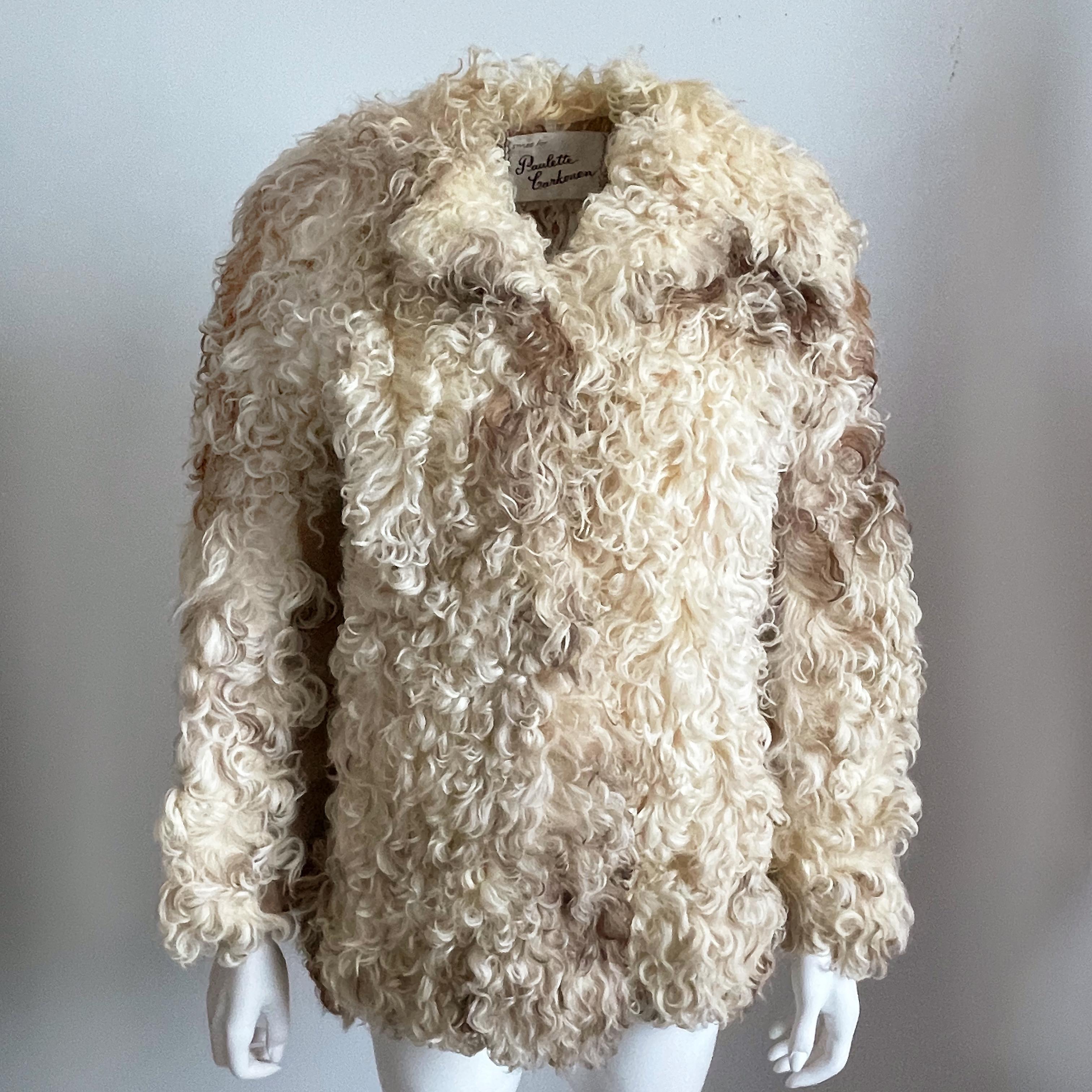 Preowned/vintage Donald Brooks Mongolian lamb fur jacket with suede leather panels, likely made in the 70s.  Fastens with hidden buttons/fully-lined/furrier & leather clean only/collar can be worn up or down.  

A gorgeous curly lamb and suede